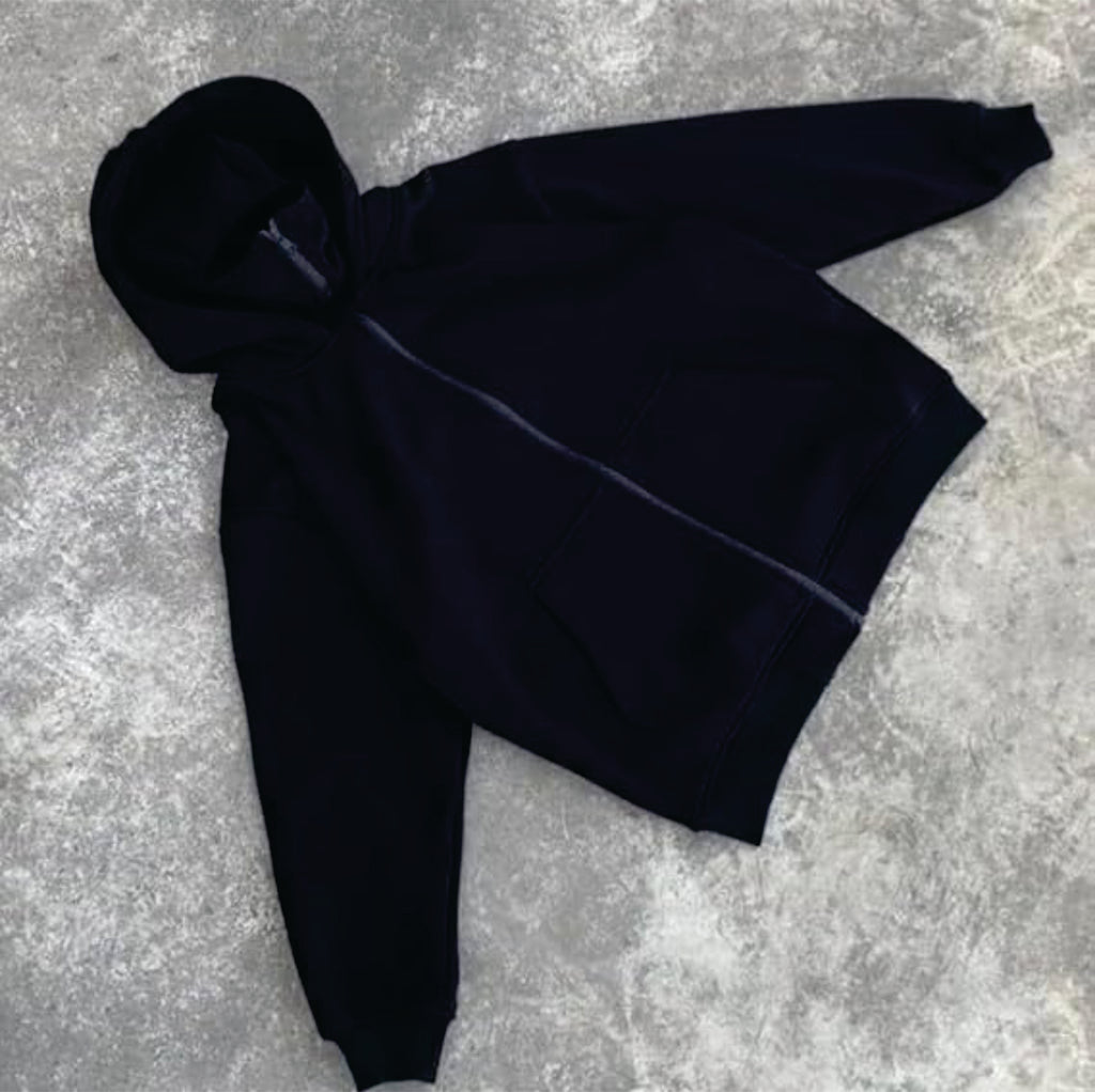 Black hoodie on a textured gray surface