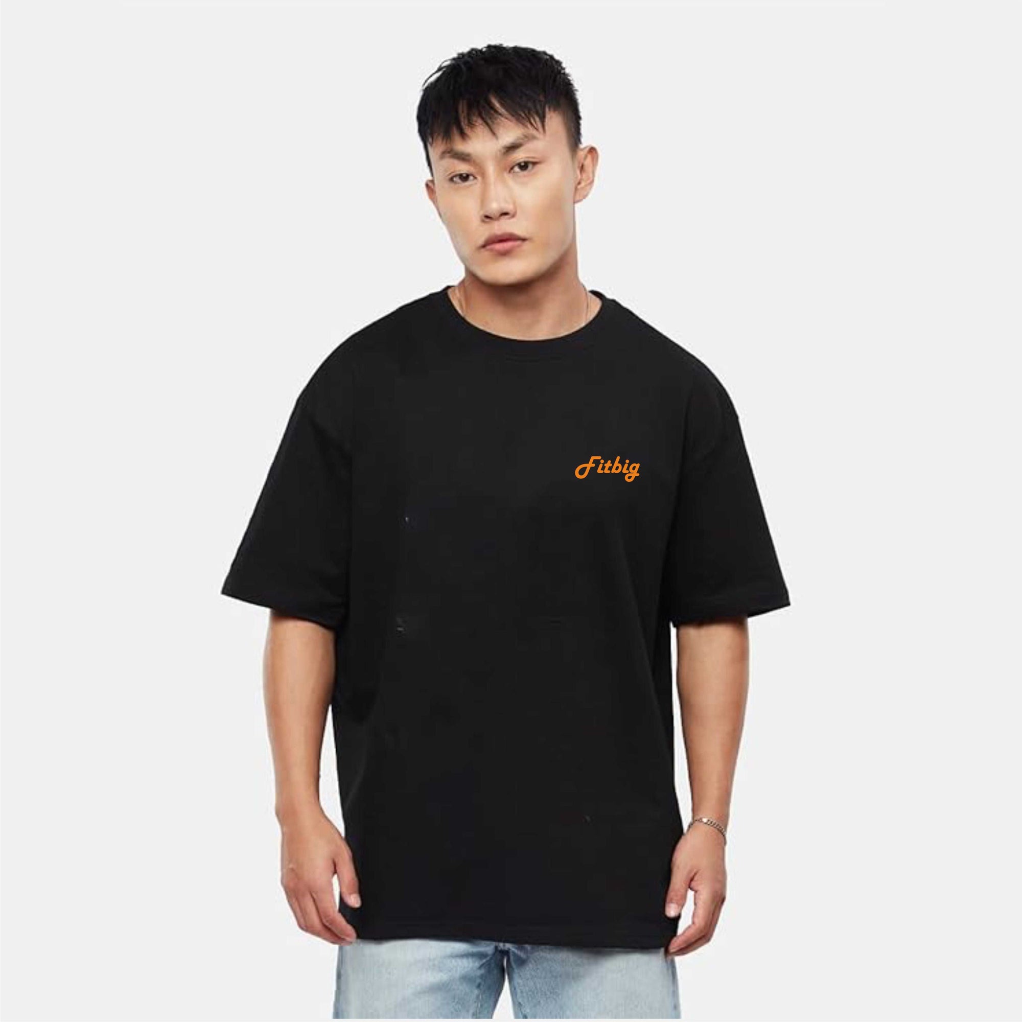 Person wearing a black t-shirt with a yellow logo on a white background