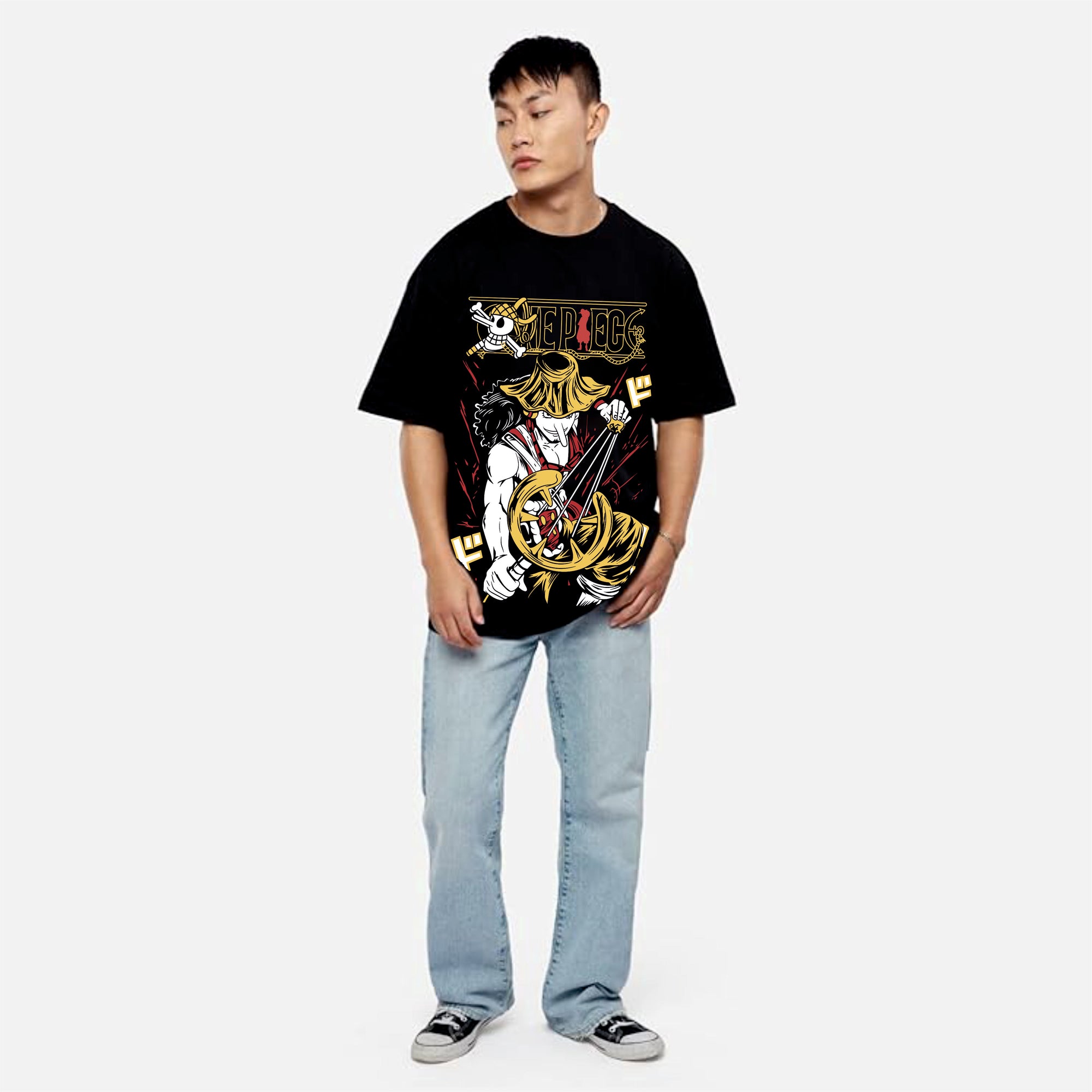 Person wearing a black graphic t-shirt and light blue jean.