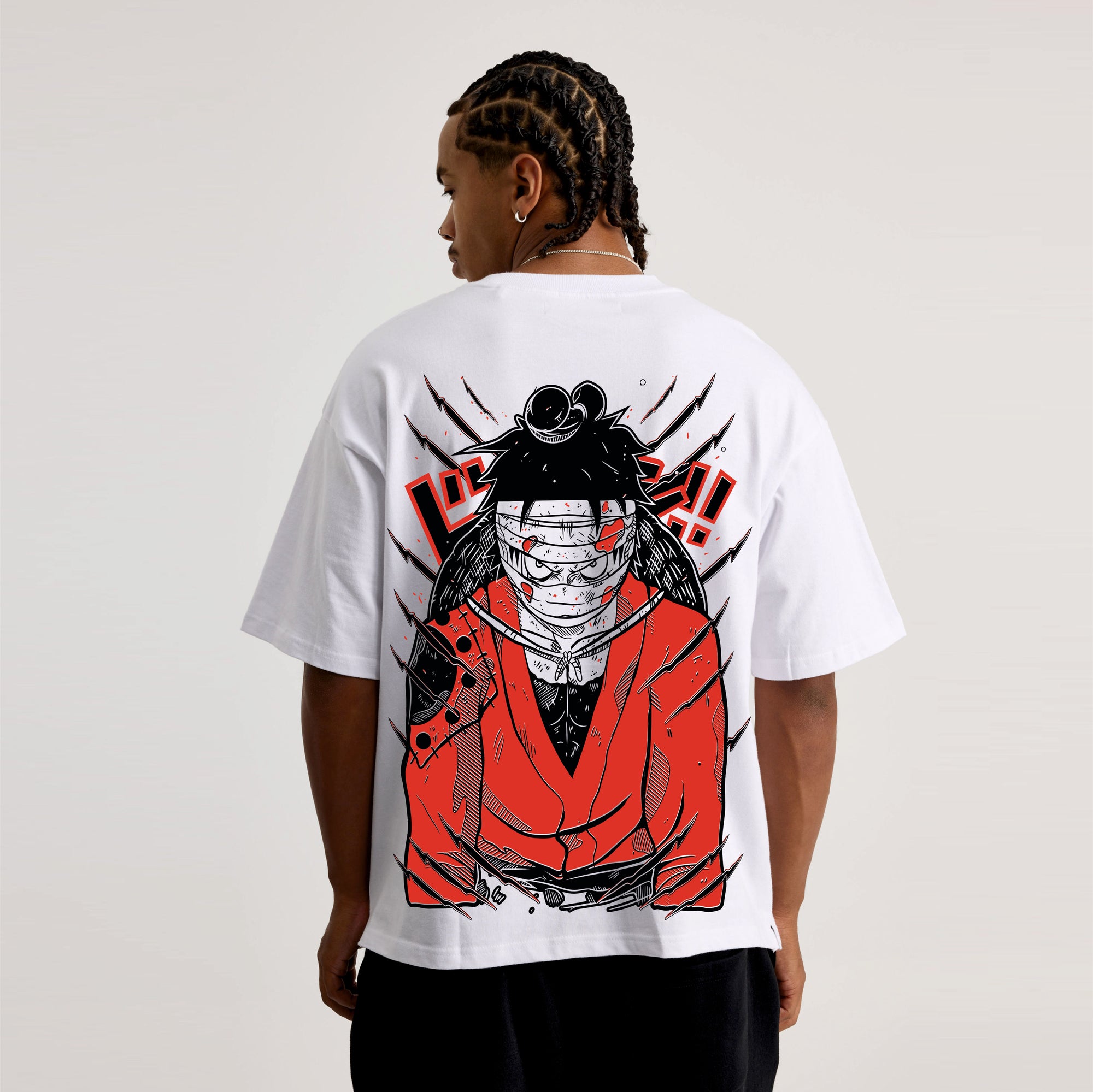 Person wearing a white t-shirt with a red and black Jujutsu kaisen graphic design on the back.
