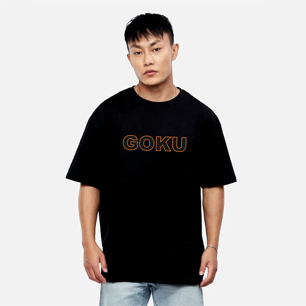 Person wearing a black t-shirt with 'GOKU' printed in orange on a white background