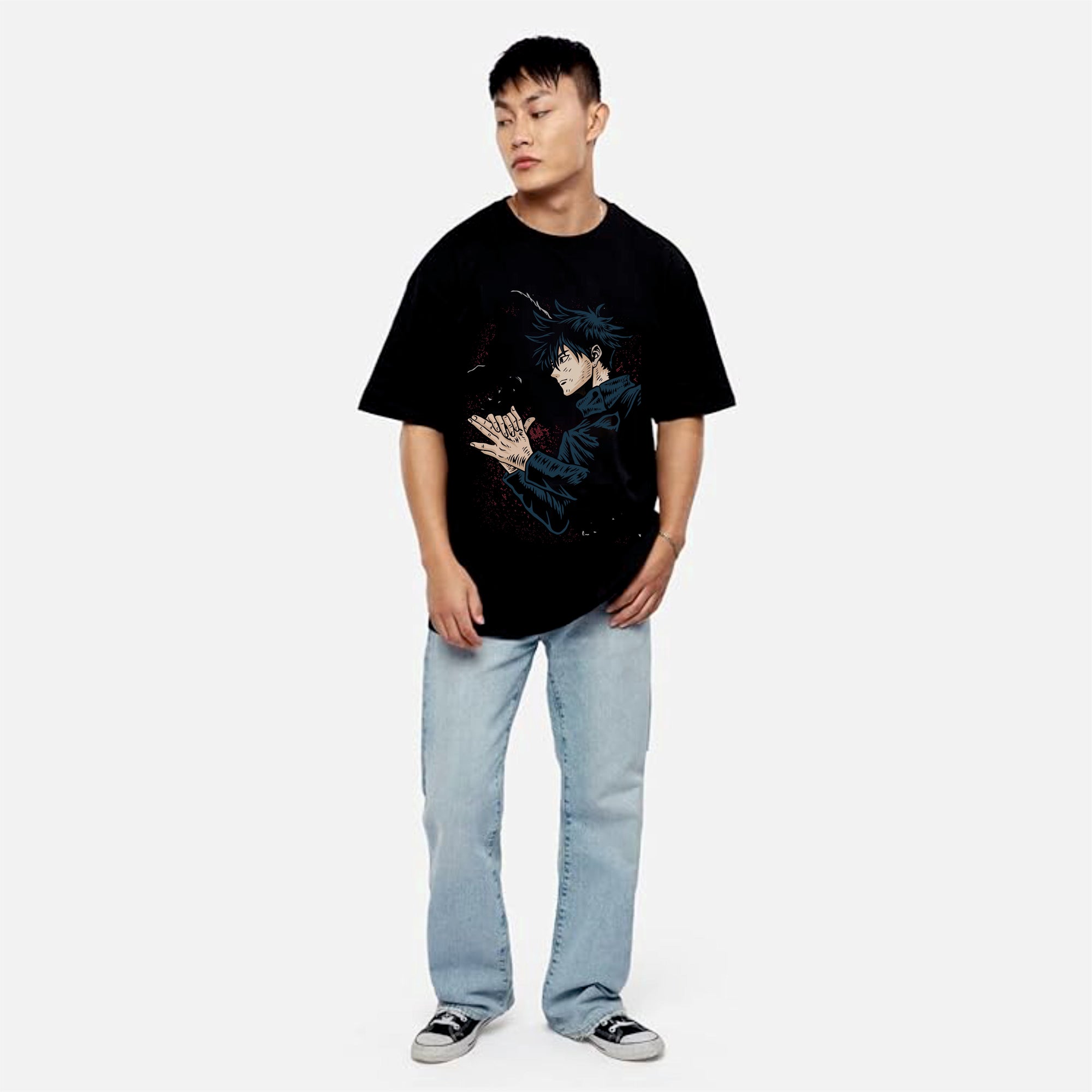 Person wearing a black t-shirt with a graphic design and light blue jeans