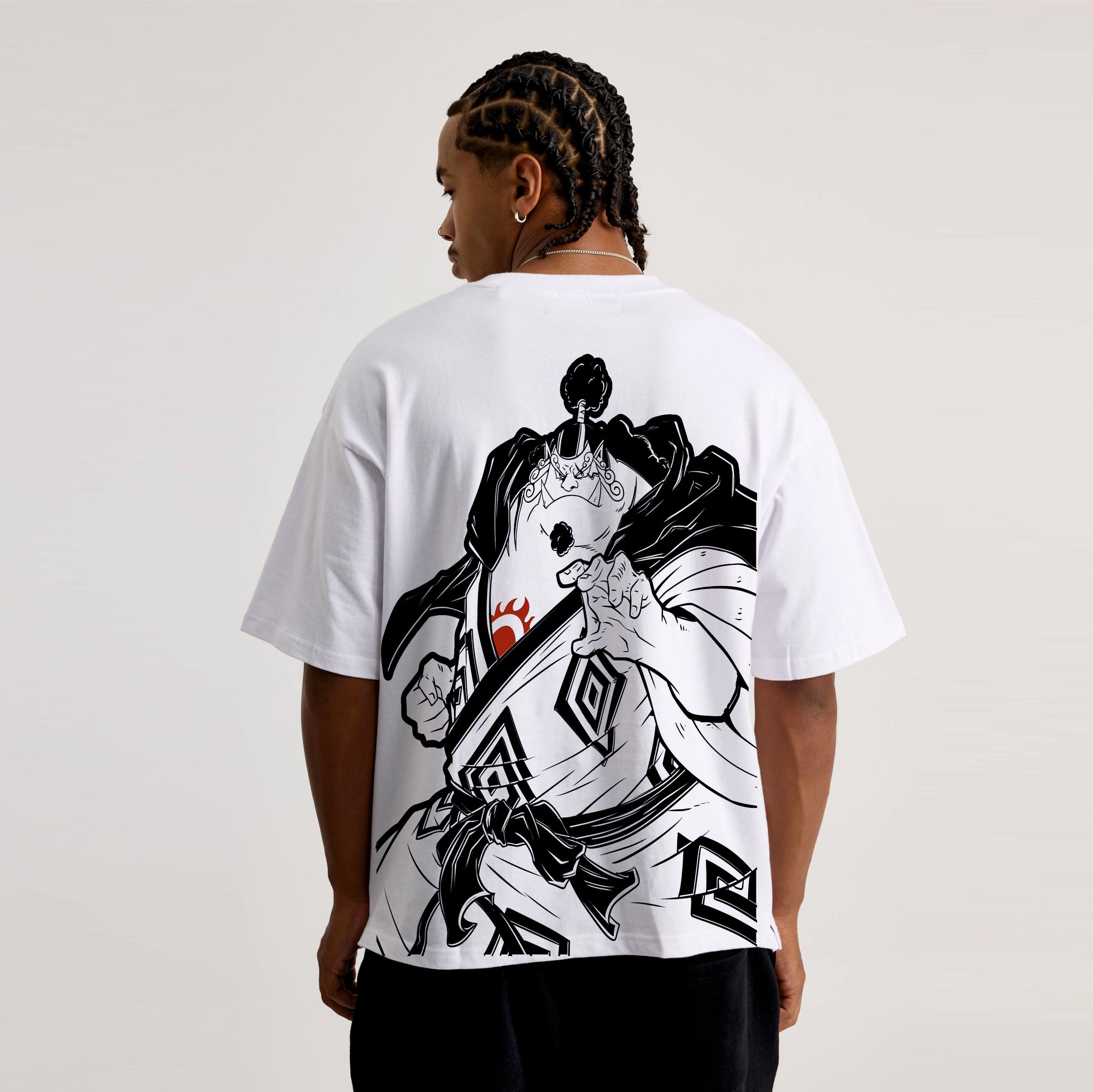 Person wearing a white t-shirt with a black and white graphic design on the back, standing against a plain background.