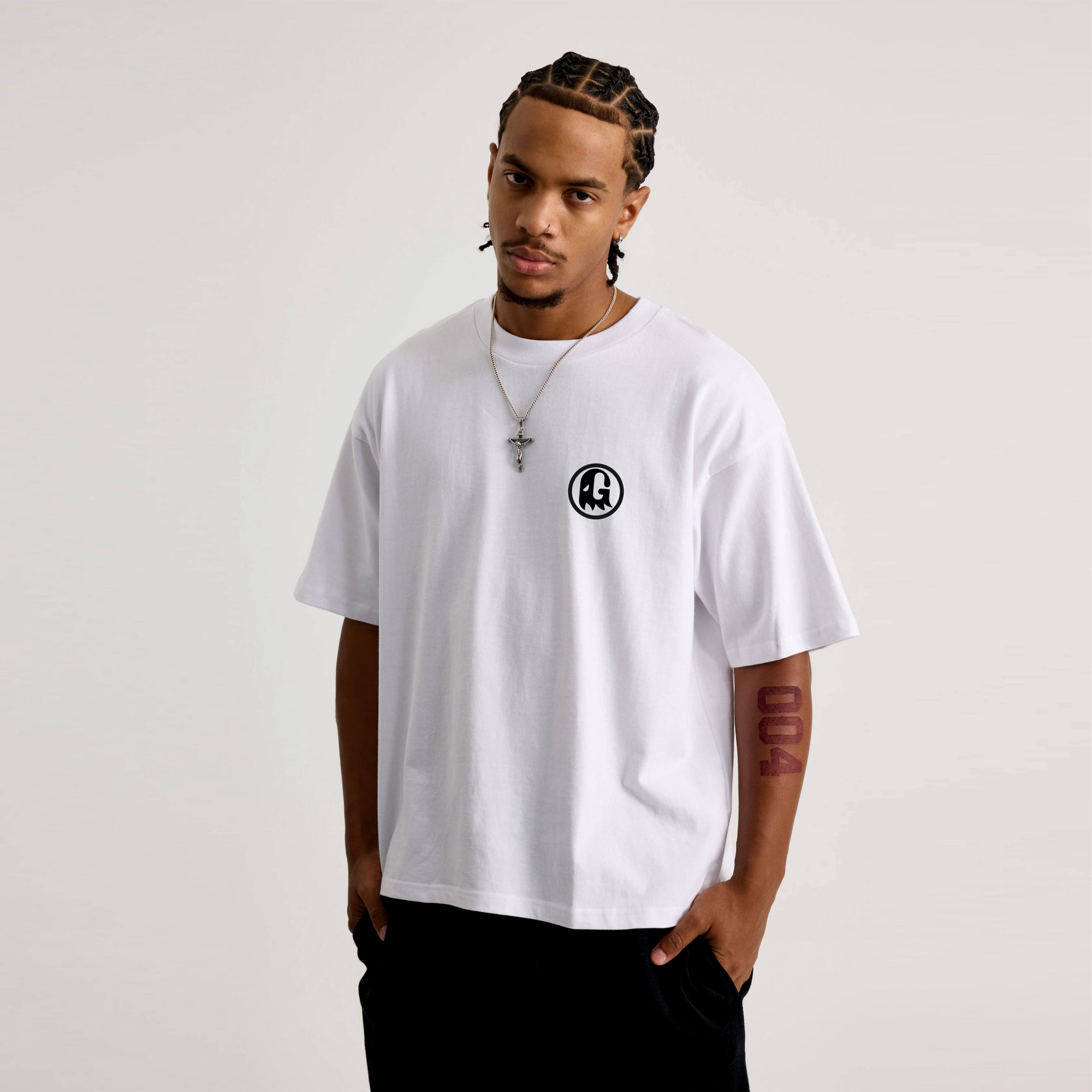 Man wearing a white t-shirt with a black logo