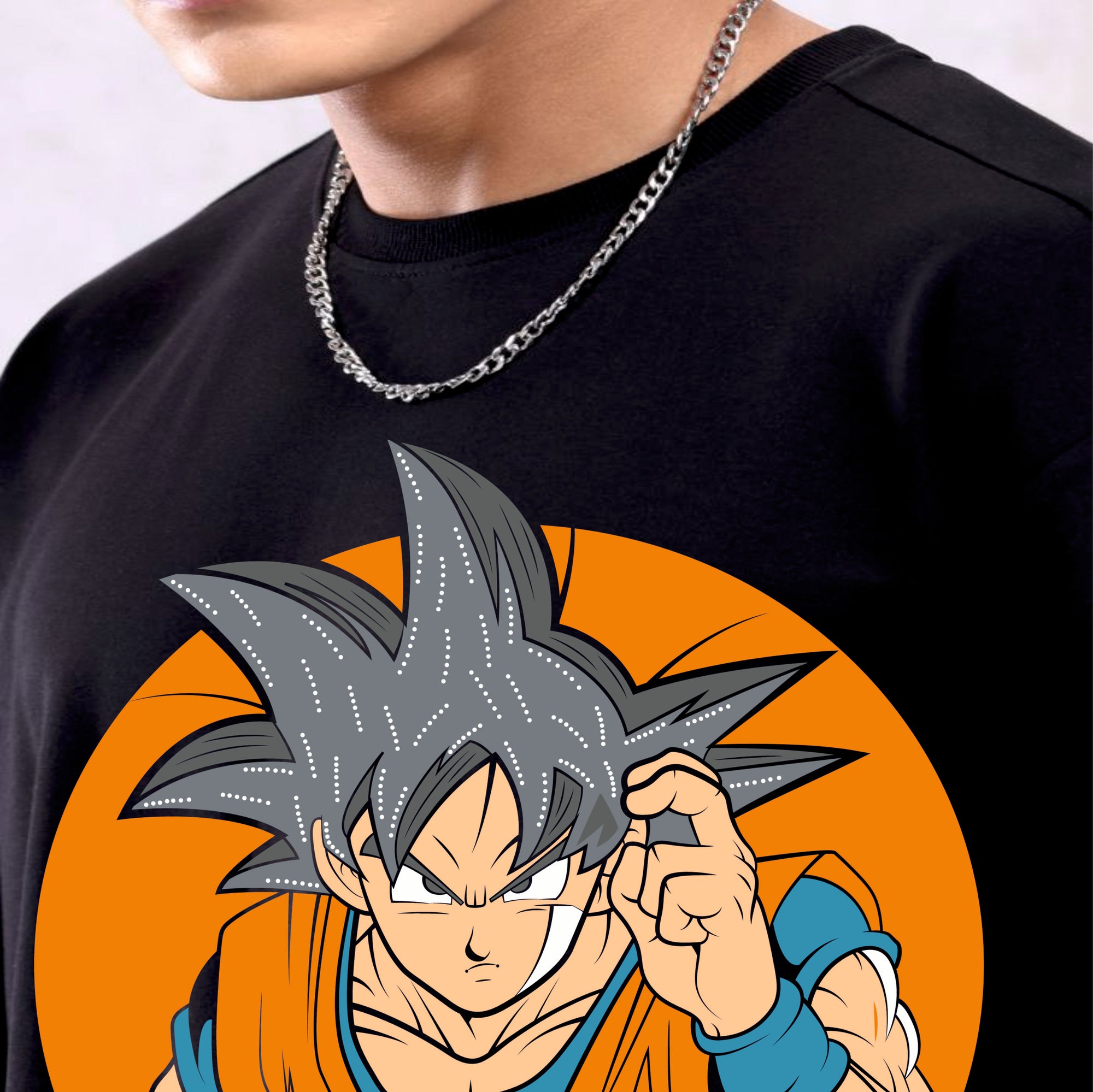 Person wearing a black t-shirt with an anime character design on an orange background