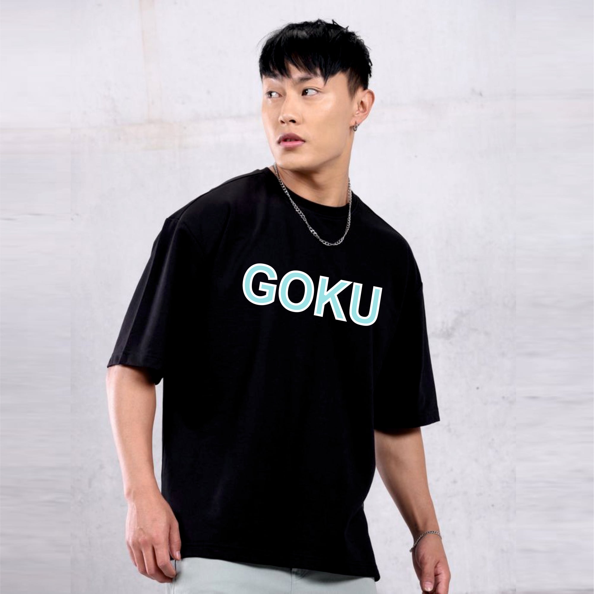 Person wearing a black t-shirt with 'GOKU' printed in green