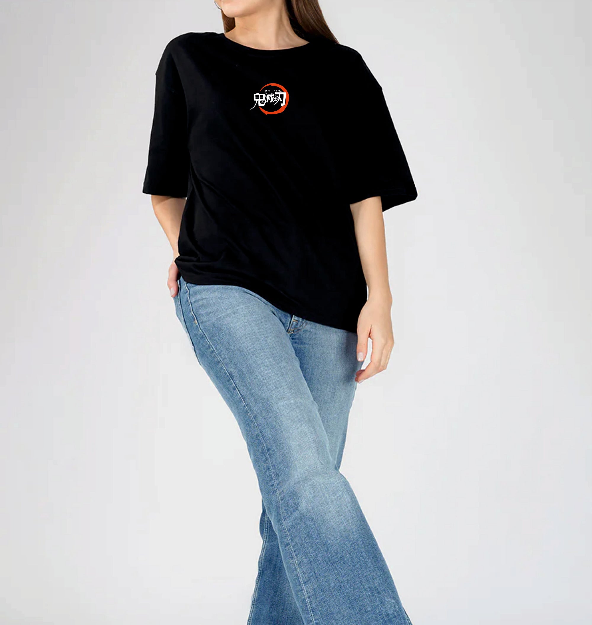 Person wearing a black t-shirt with a logo and blue jeans 