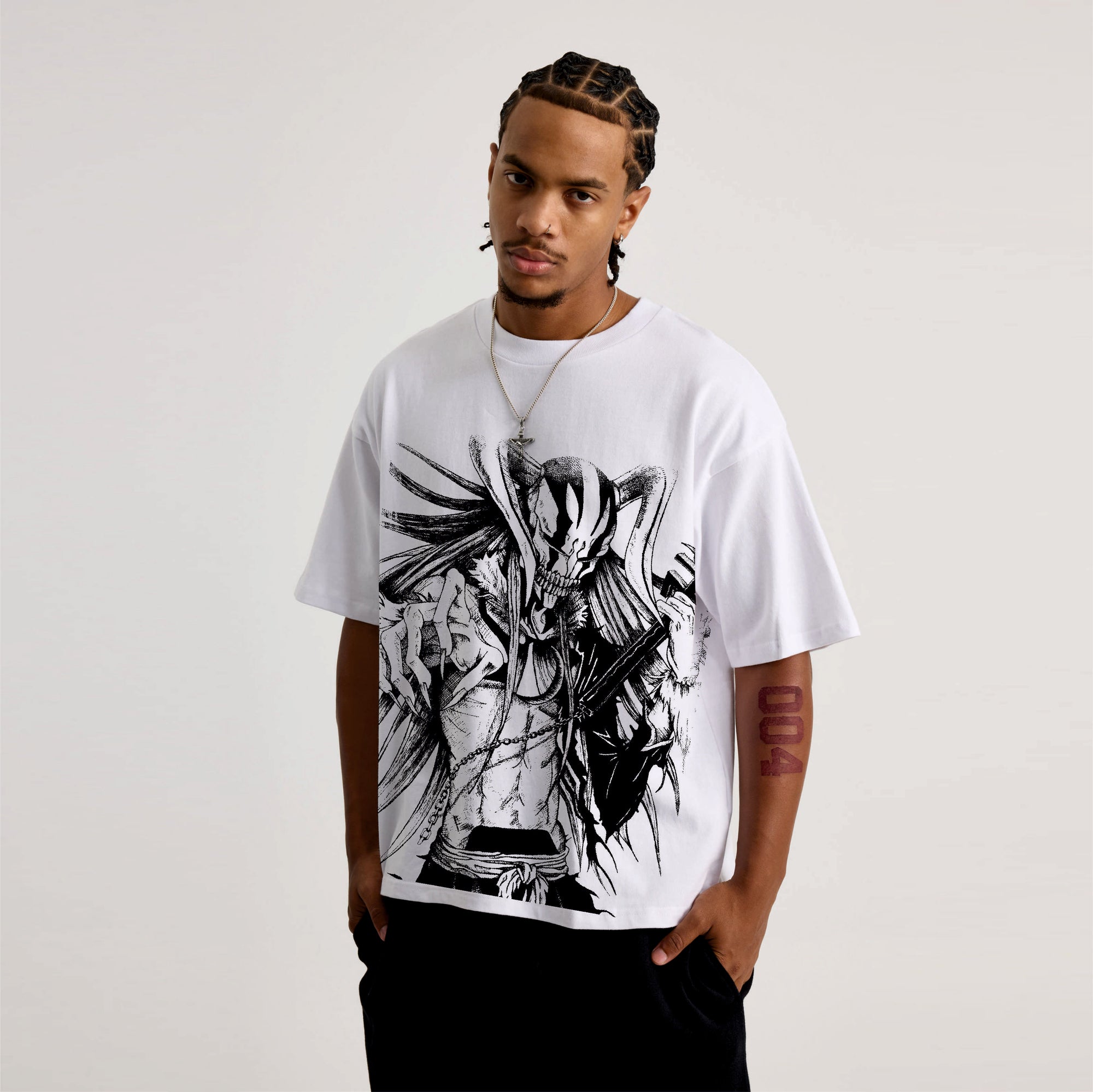Person wearing a white t-shirt with black abstract design on a plain background