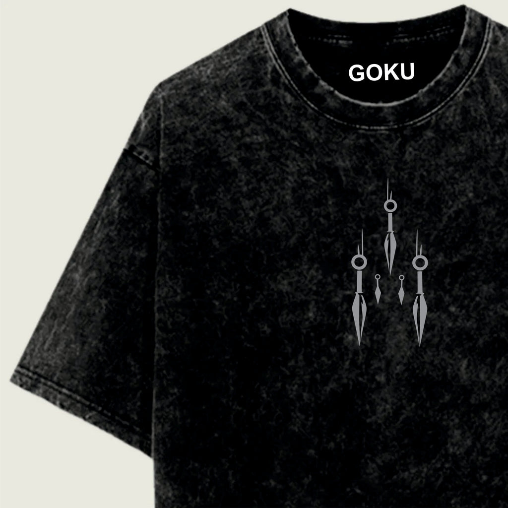 Black t-shirt with 'GOKU' branding and decorative design on a light green background