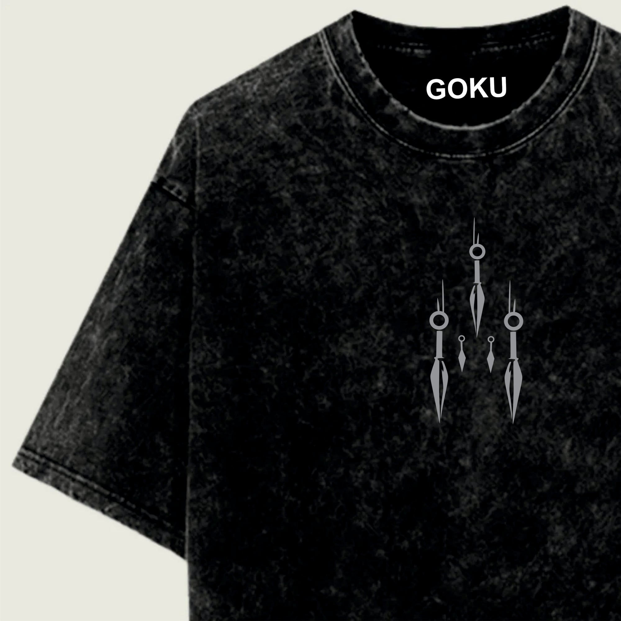 Black t-shirt with 'GOKU' branding and decorative design on a light green background