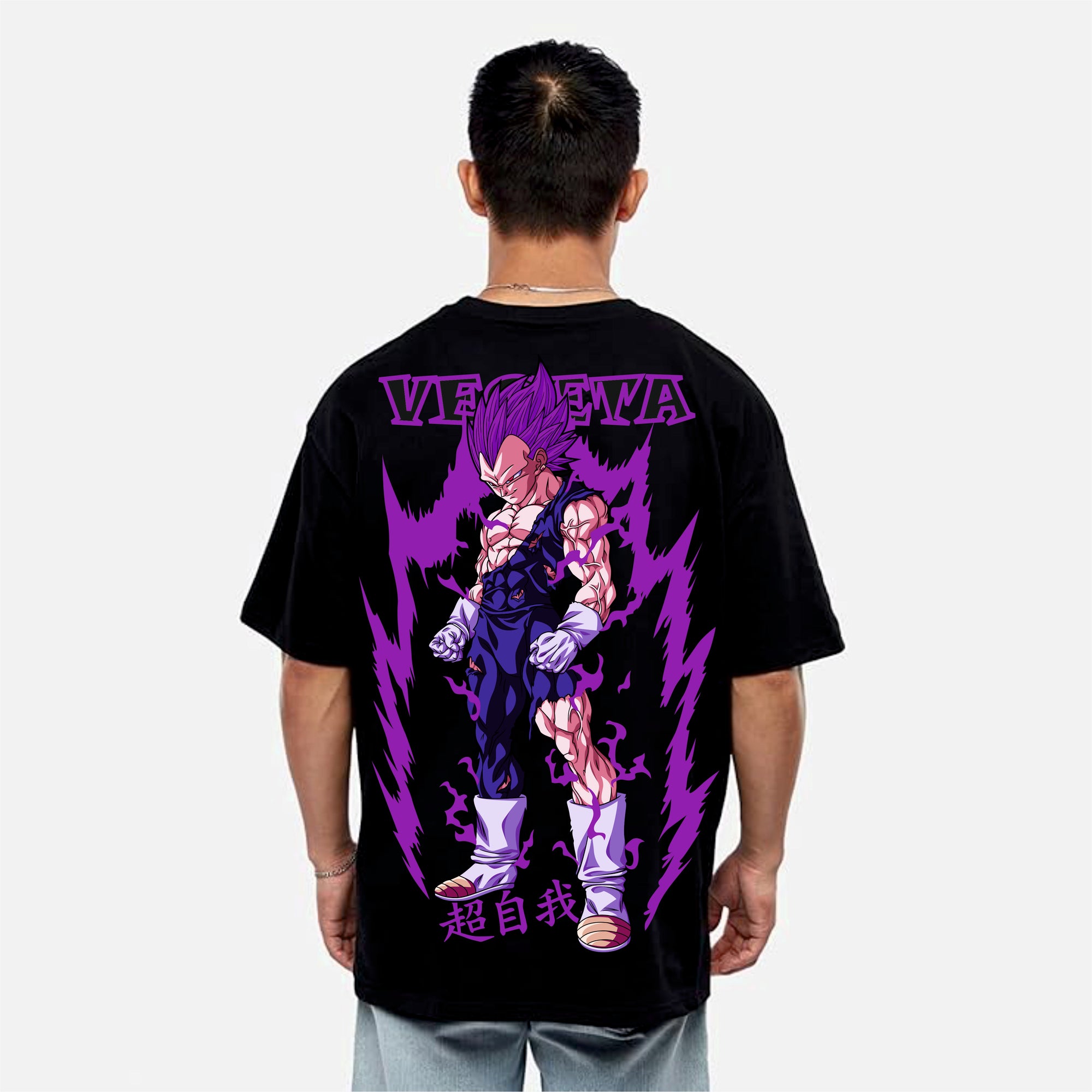 Person wearing a black t-shirt with a colorful graphic design on the back, featuring the word 'Vegeta' and a character in a dynamic pose.