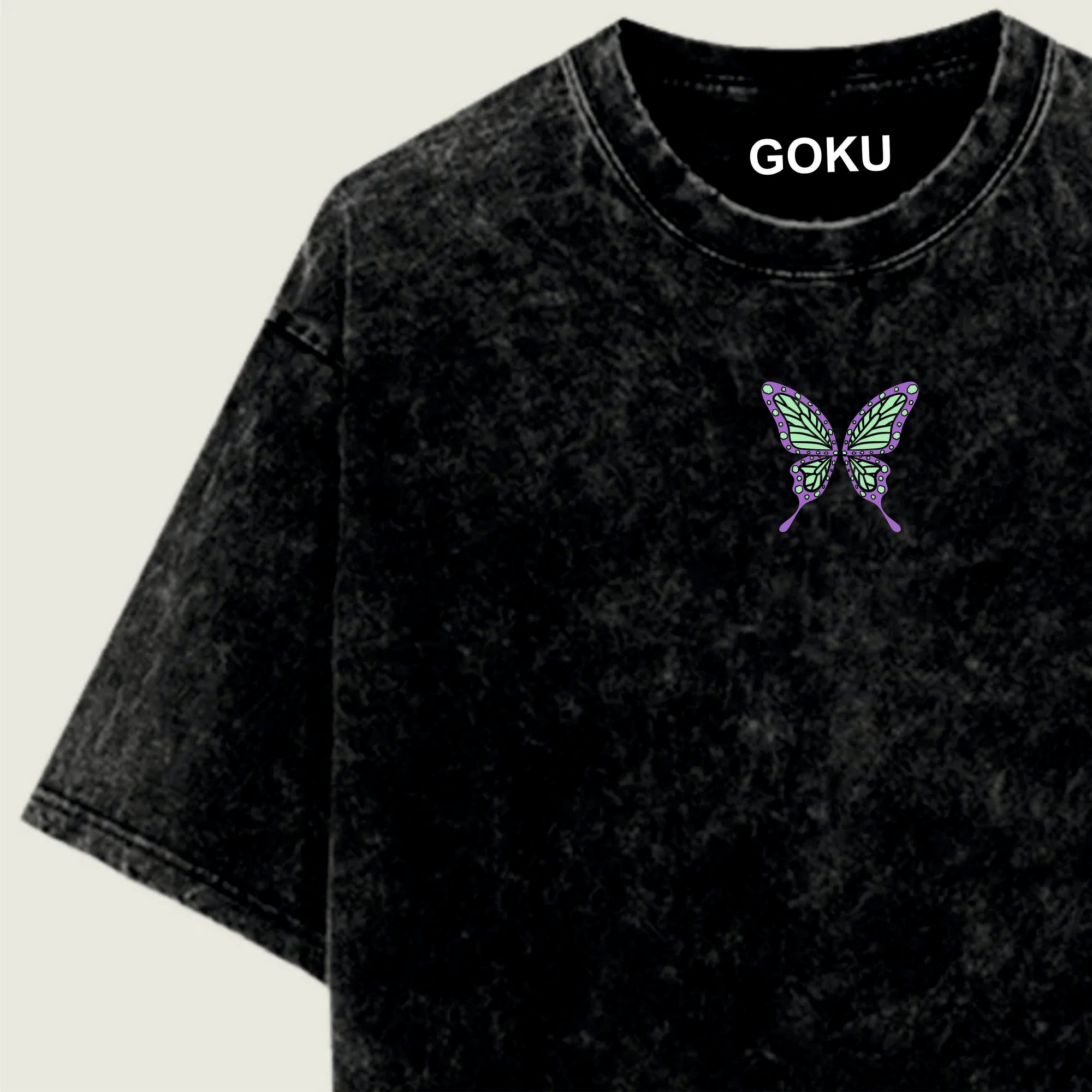 Black t-shirt with a butterfly design and 'GOKU' text on a light green background