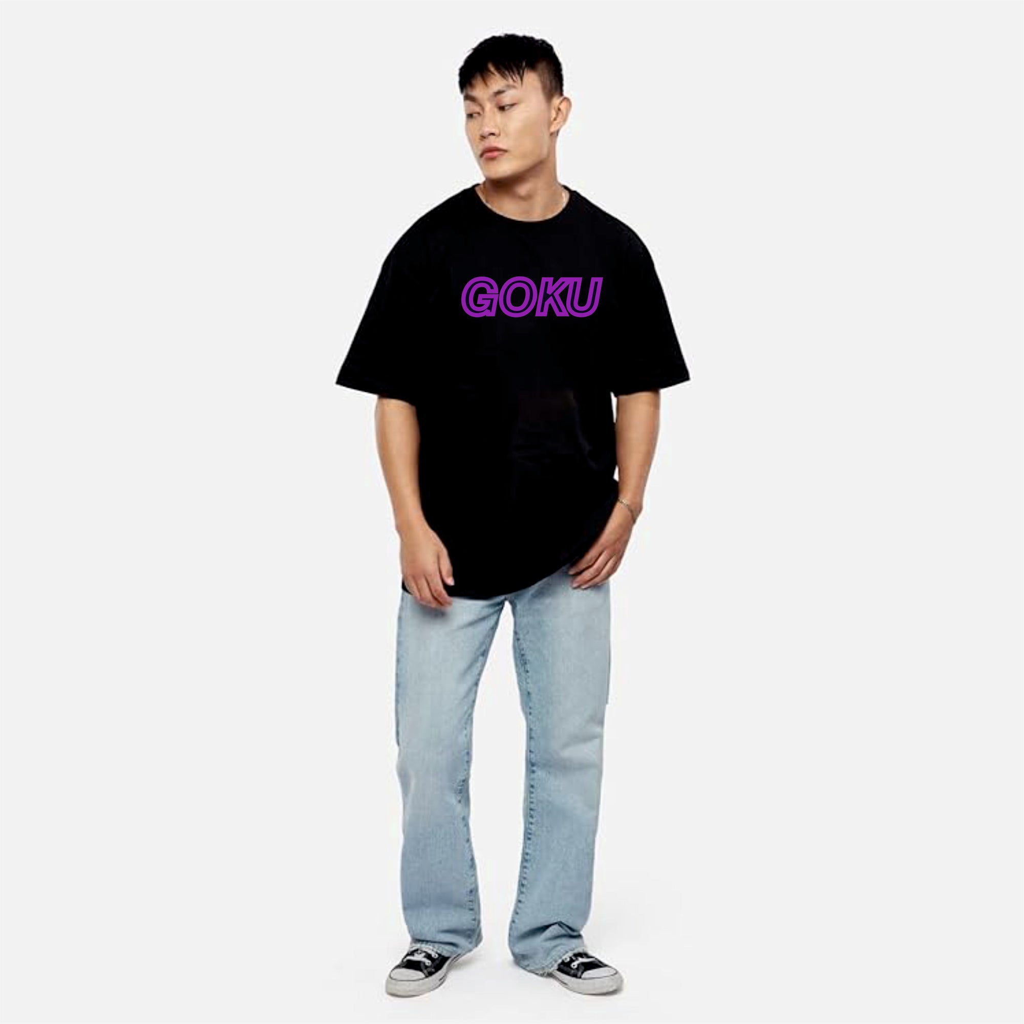 Person wearing a black t-shirt with 'GOKU' text and light blue jeans on a white background