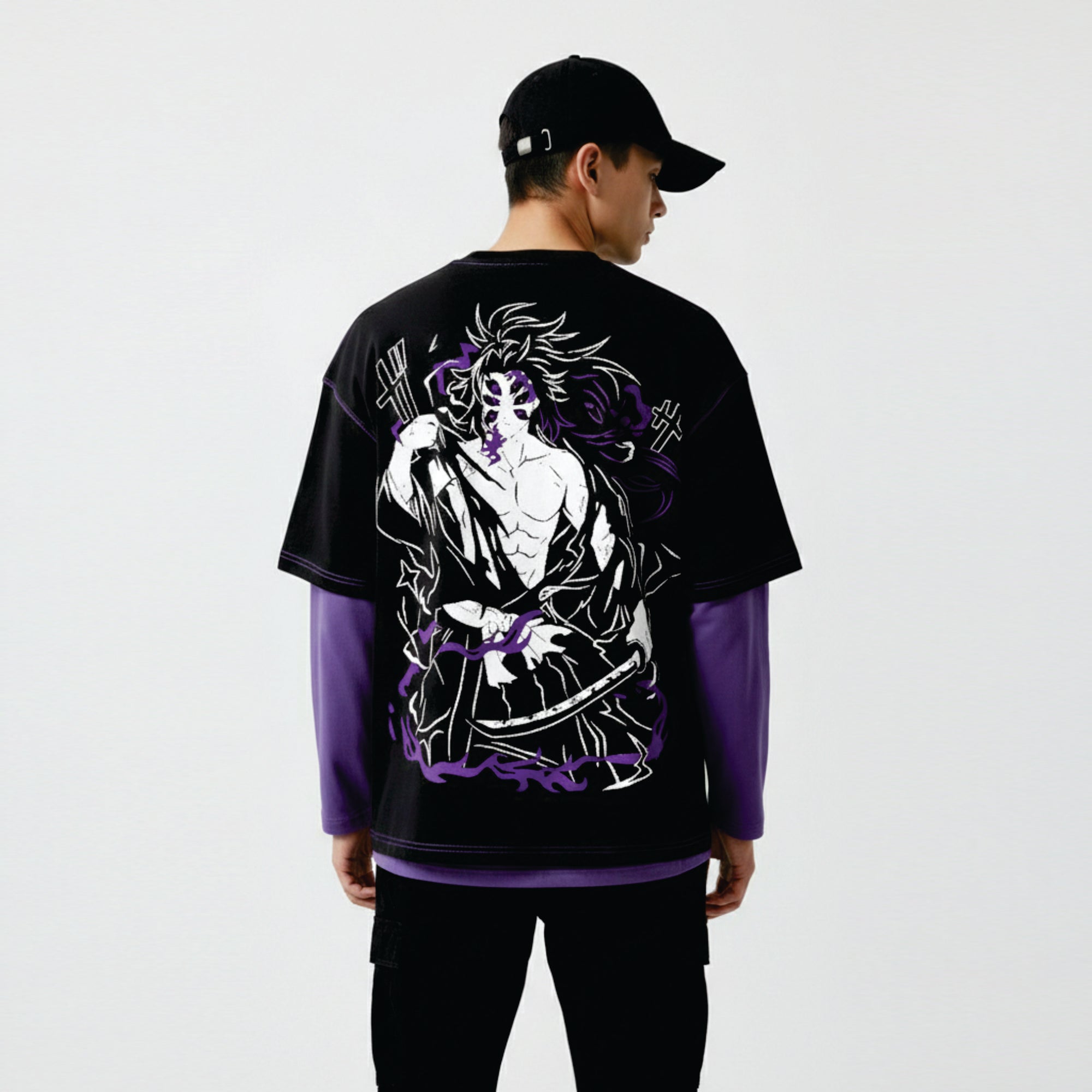 Person wearing a black and purple graphic t-shirt with a design on the back against a white background