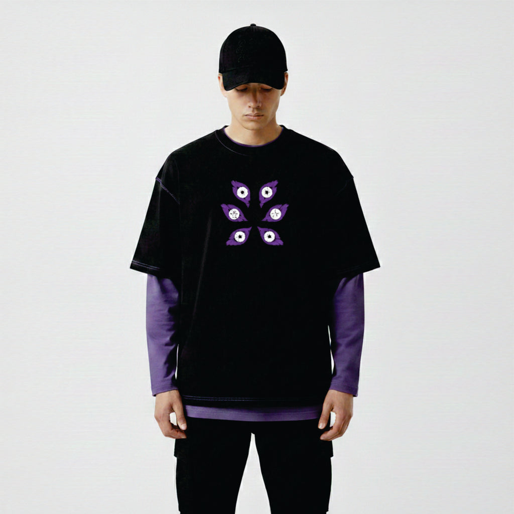 Person wearing a black and purple outfit with a unique design on a white background