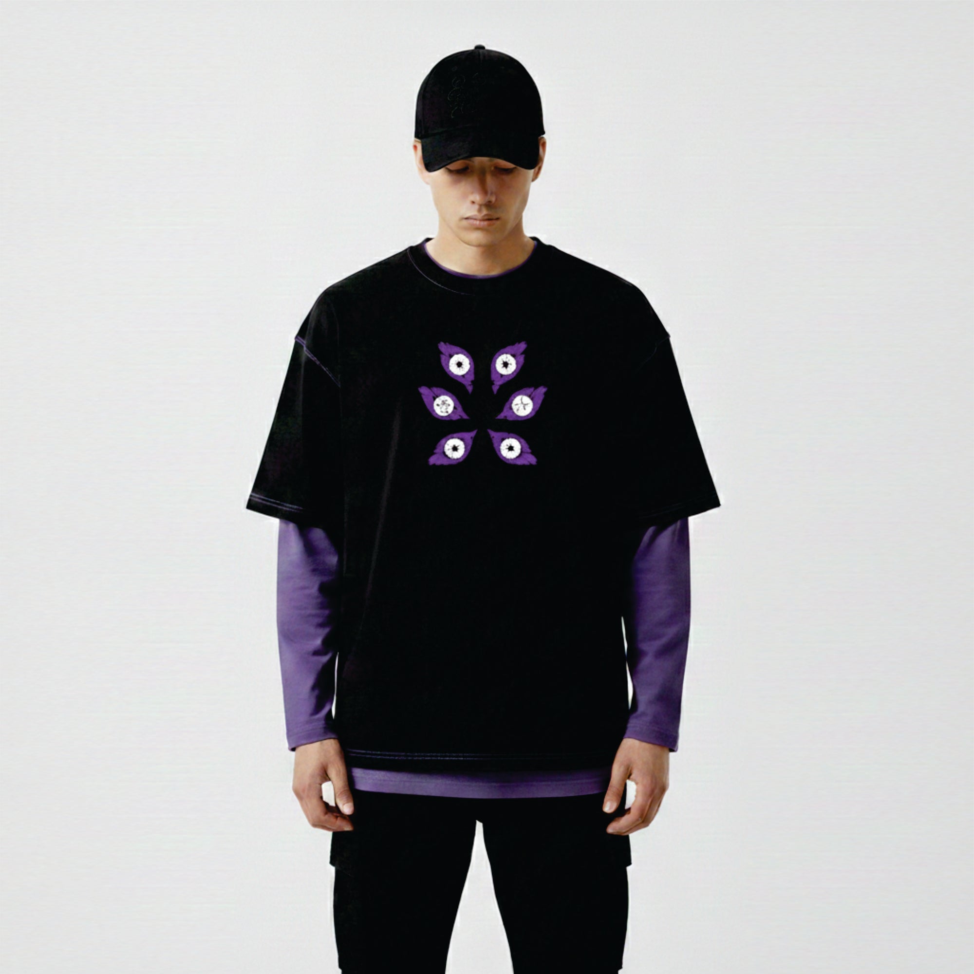 Person wearing a black and purple outfit with a unique design on a white background