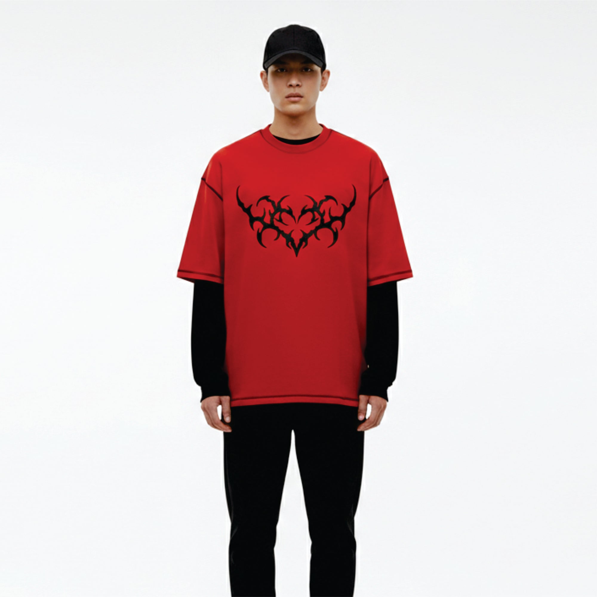 Person wearing a red t-shirt with black tribal design on a white background