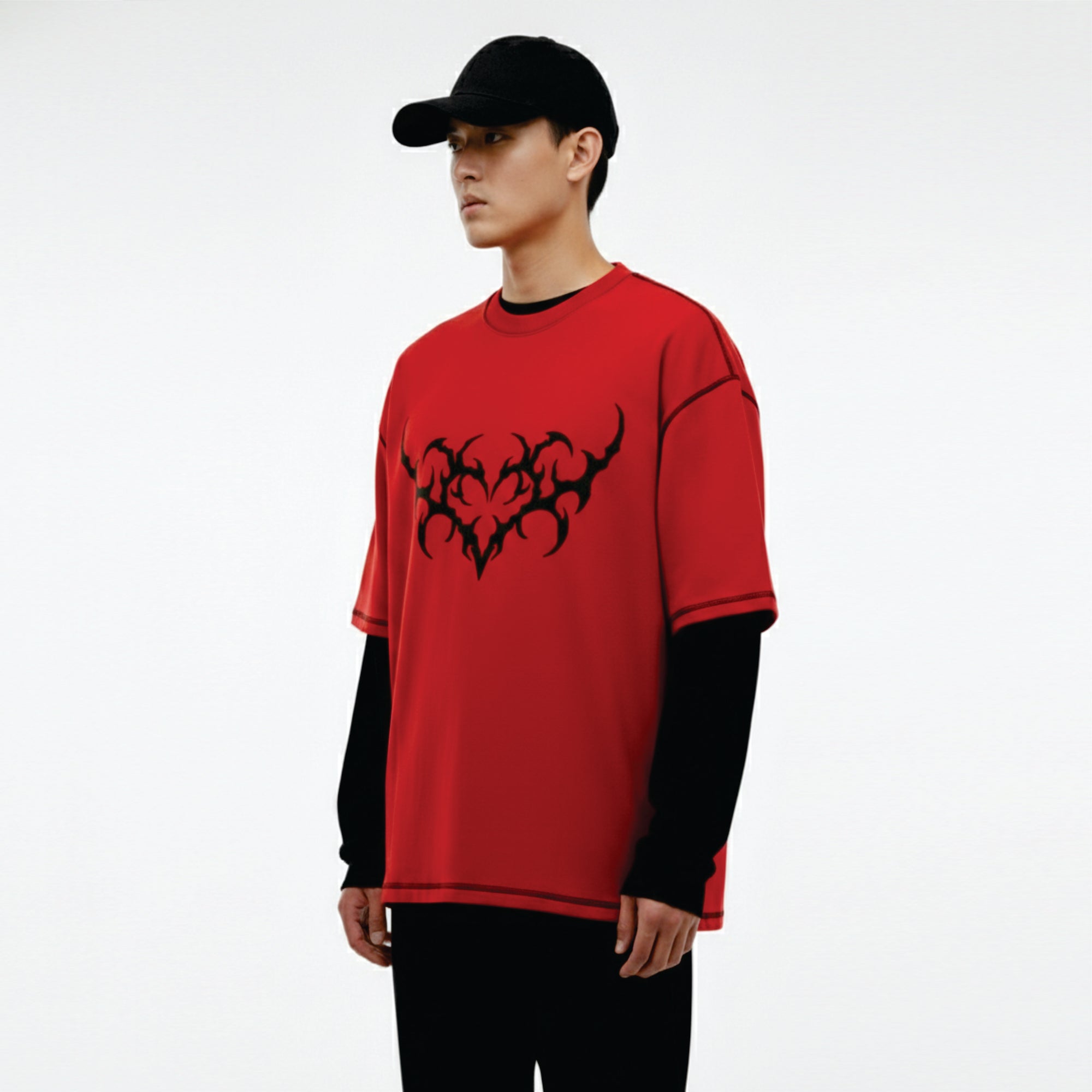 Person wearing a red shirt with black design on a white background