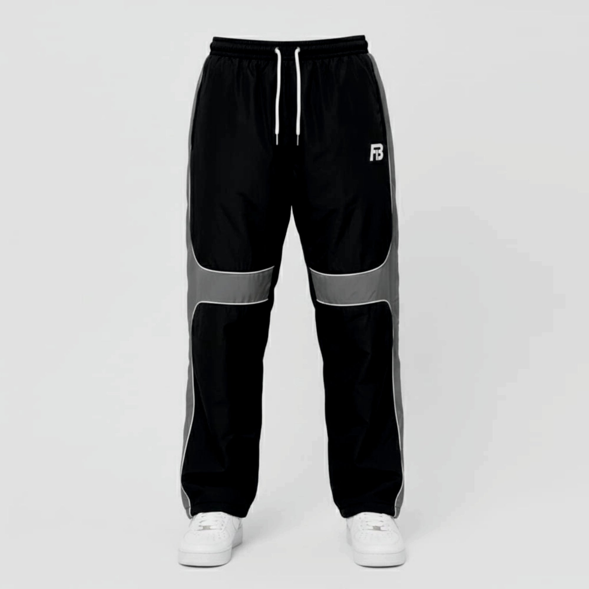 Black and gray track pants with a brand logo on a light gray background