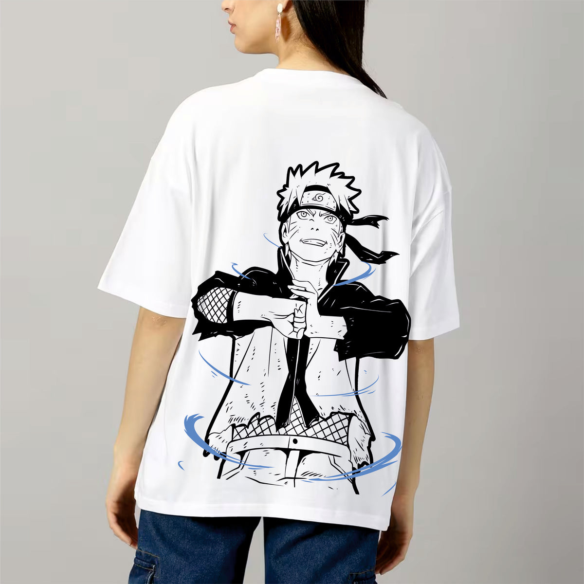Person wearing a white t-shirt with a black and blue graphic design on the back.