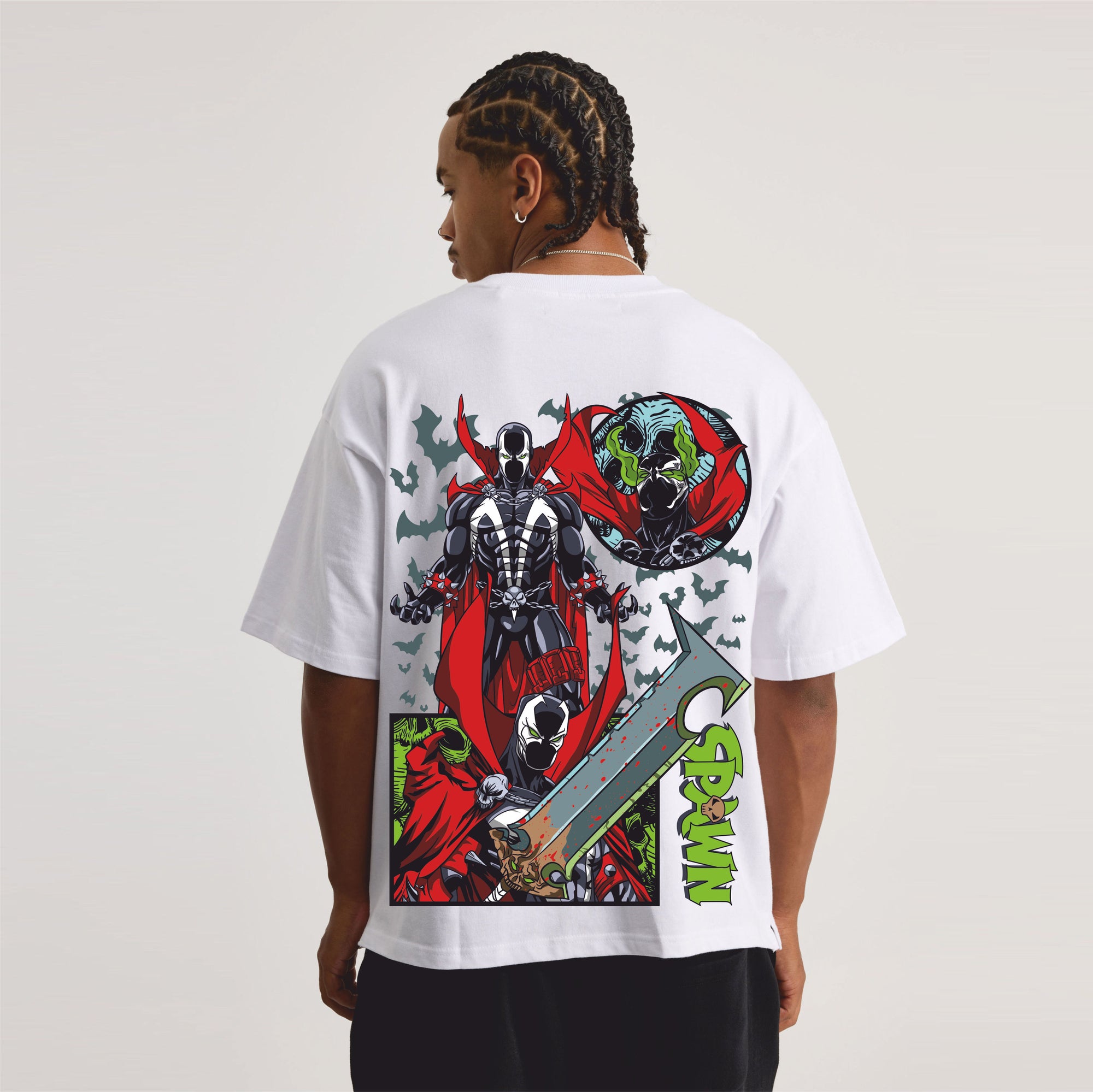 Person wearing a white t-shirt with a colorful graphic design on the back