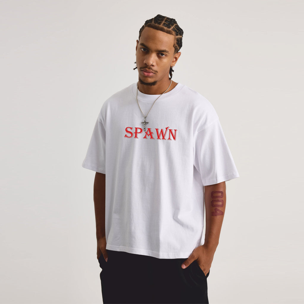 Person wearing a white t-shirt with 'SPAWN' printed in red on a plain background
