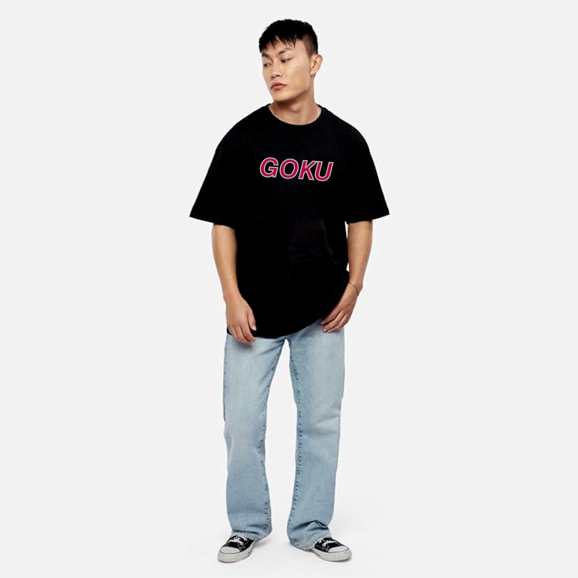 Person wearing a black t-shirt with 'GOKU' printed in pink on a white background