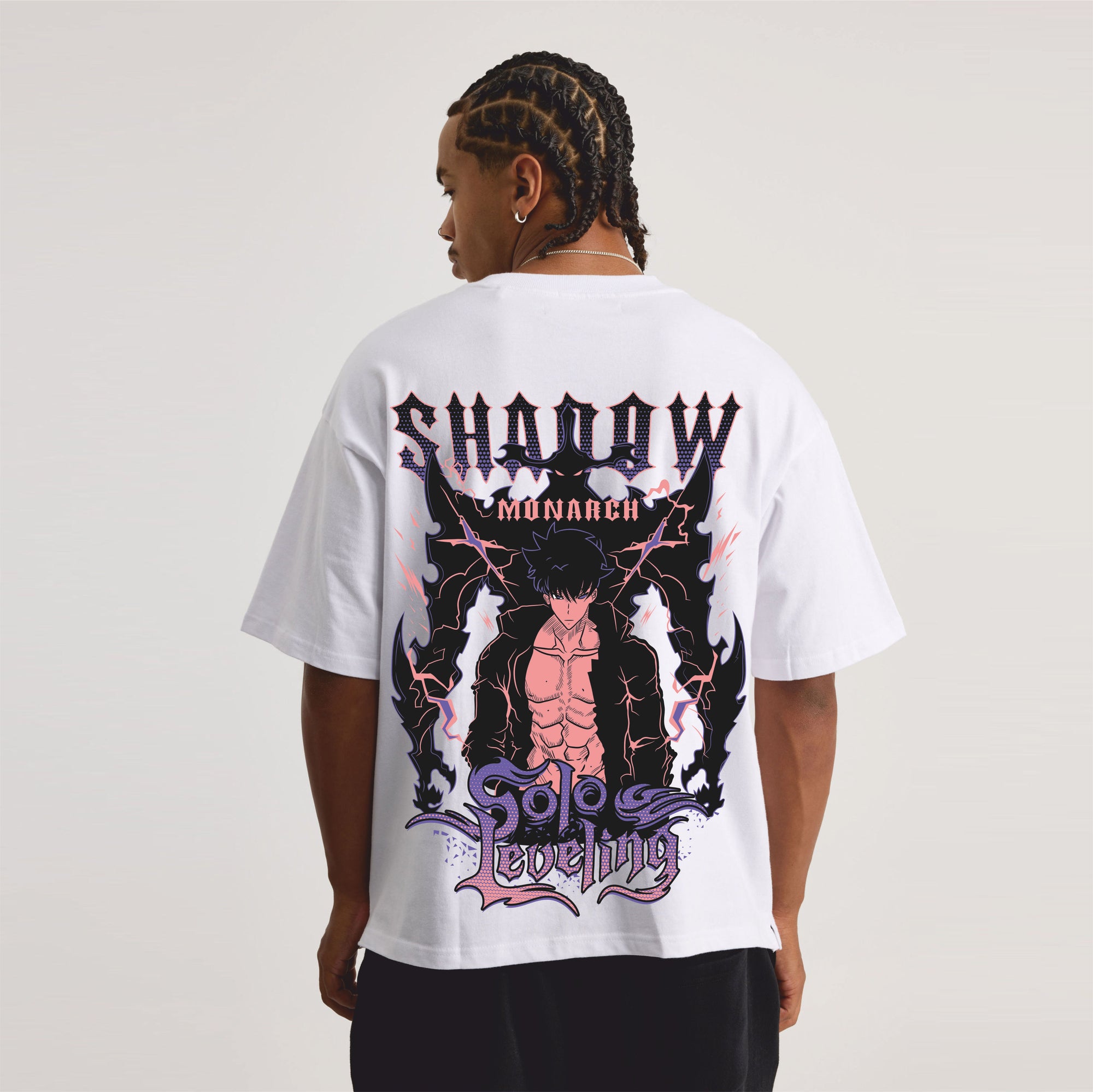 Person wearing a white t-shirt with a graphic design on the back.