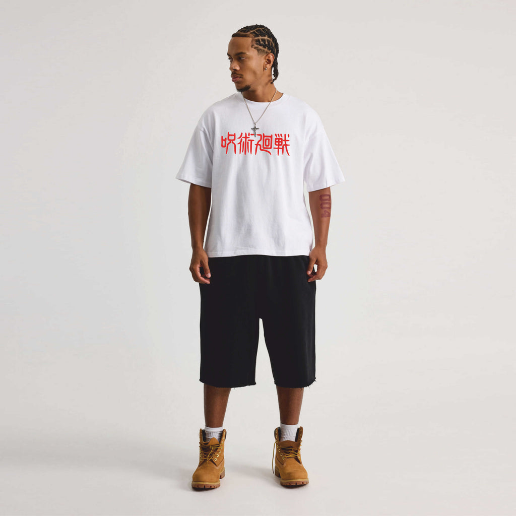 Person wearing a white t-shirt with red jujutsu  text, black shorts.