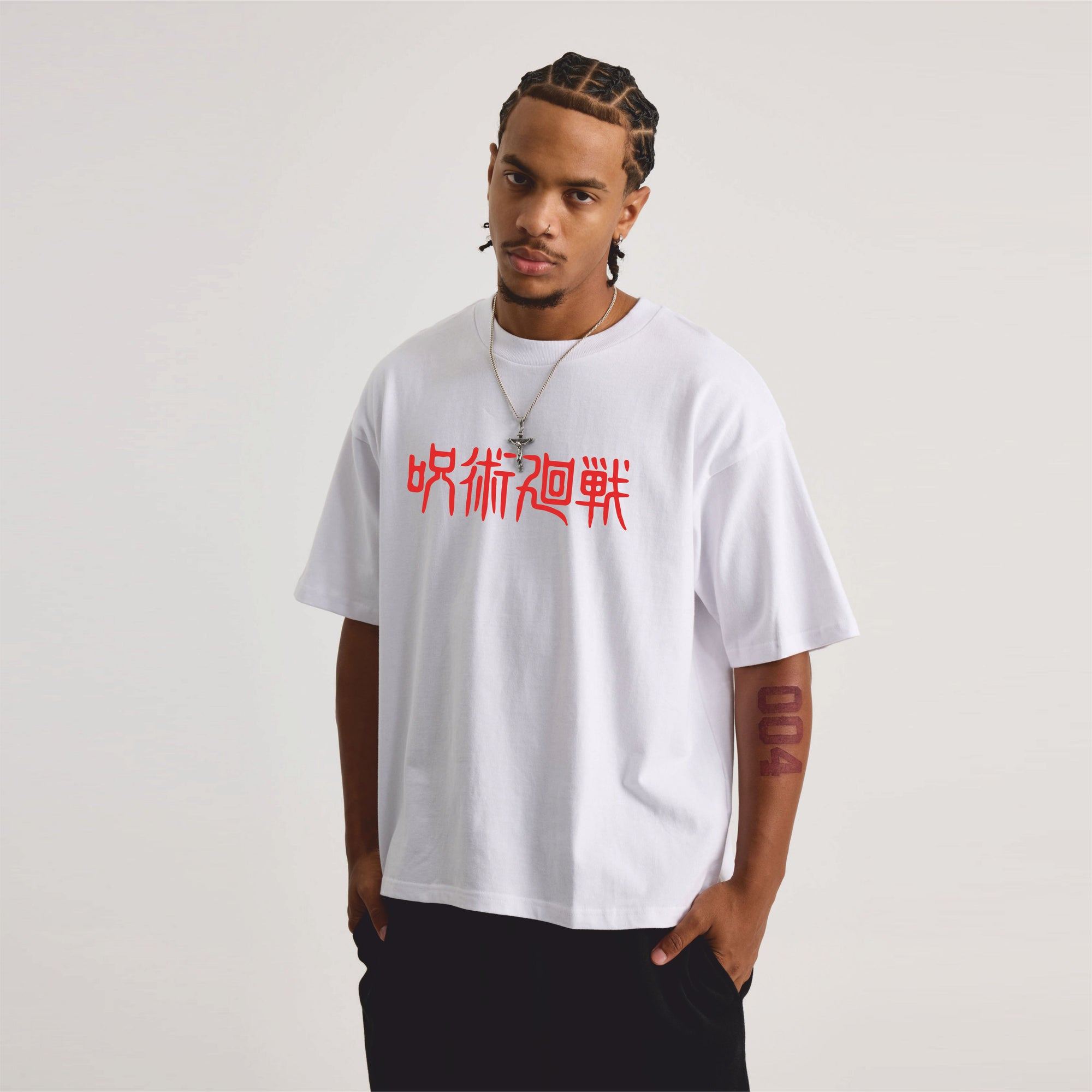 Person wearing a white t-shirt with jujutsu red text.