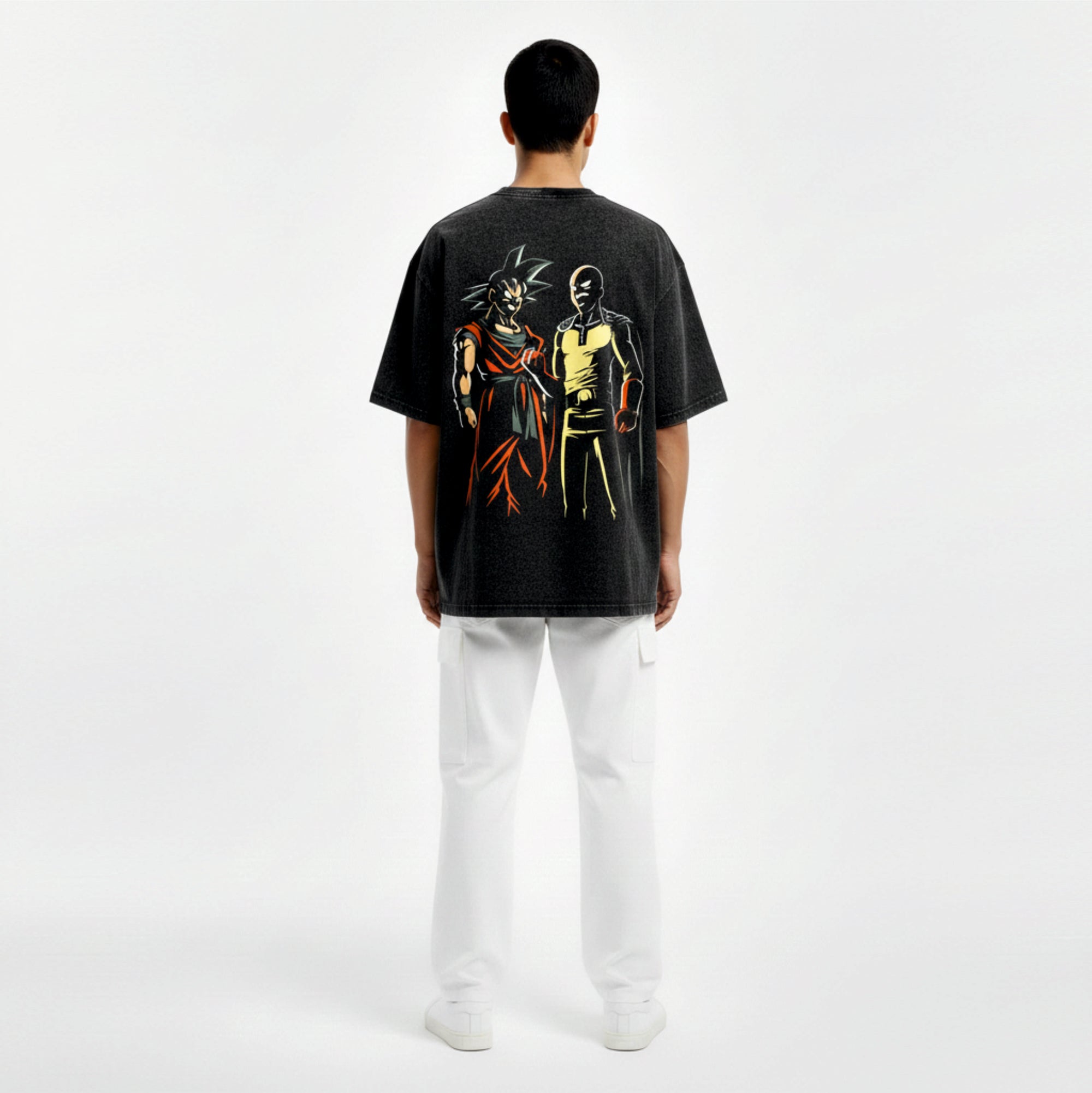 Person wearing a black t-shirt with colorful graphic design on the back, standing against a white background