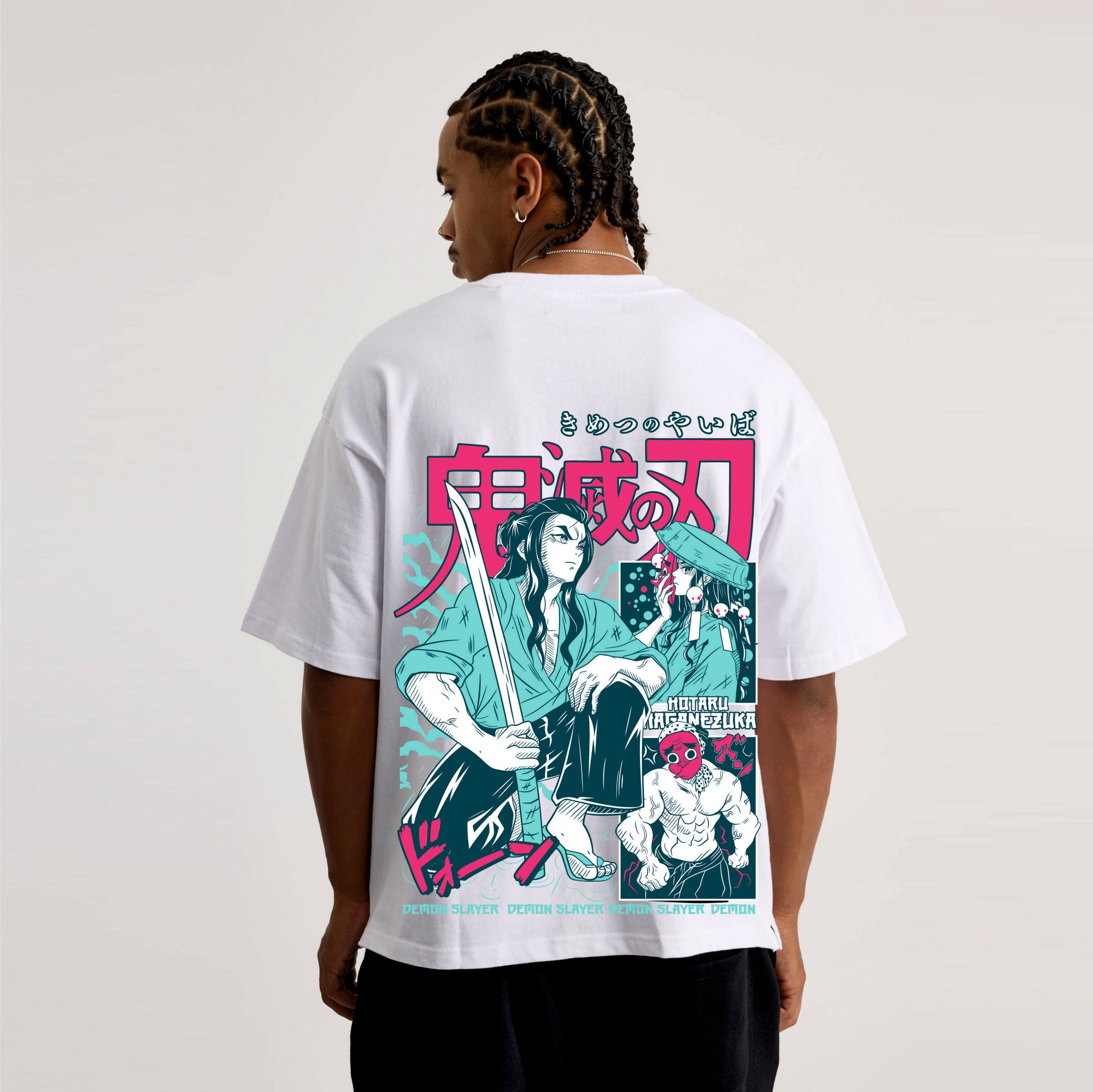 Person wearing a white t-shirt with a colorful graphic Demon slayer design on the back.