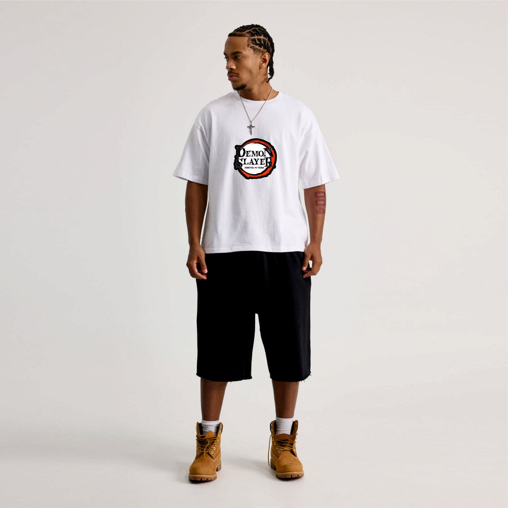 Person wearing a white t-shirt with a logo Demon slayer.