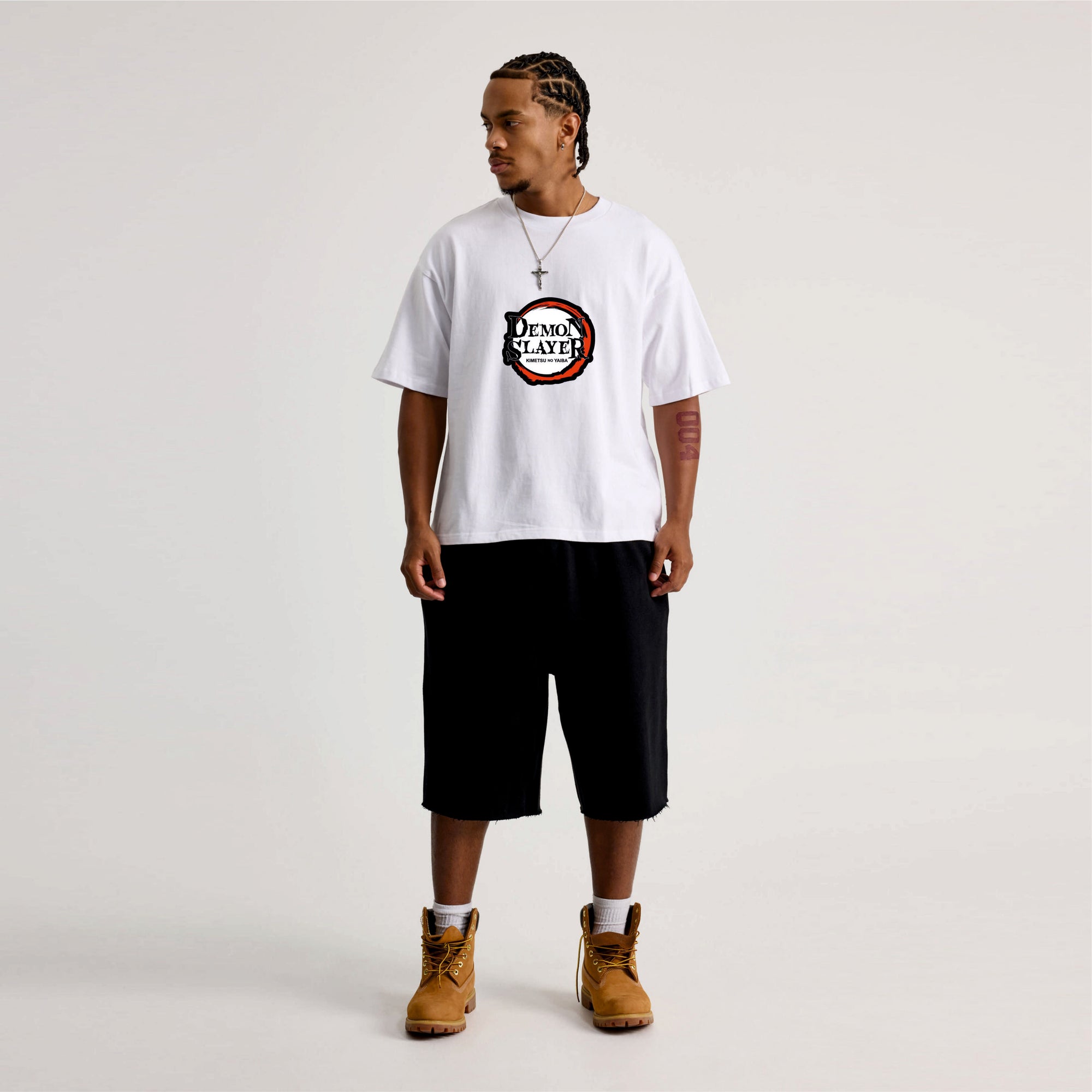 Person wearing a white t-shirt with a logo Demon slayer.