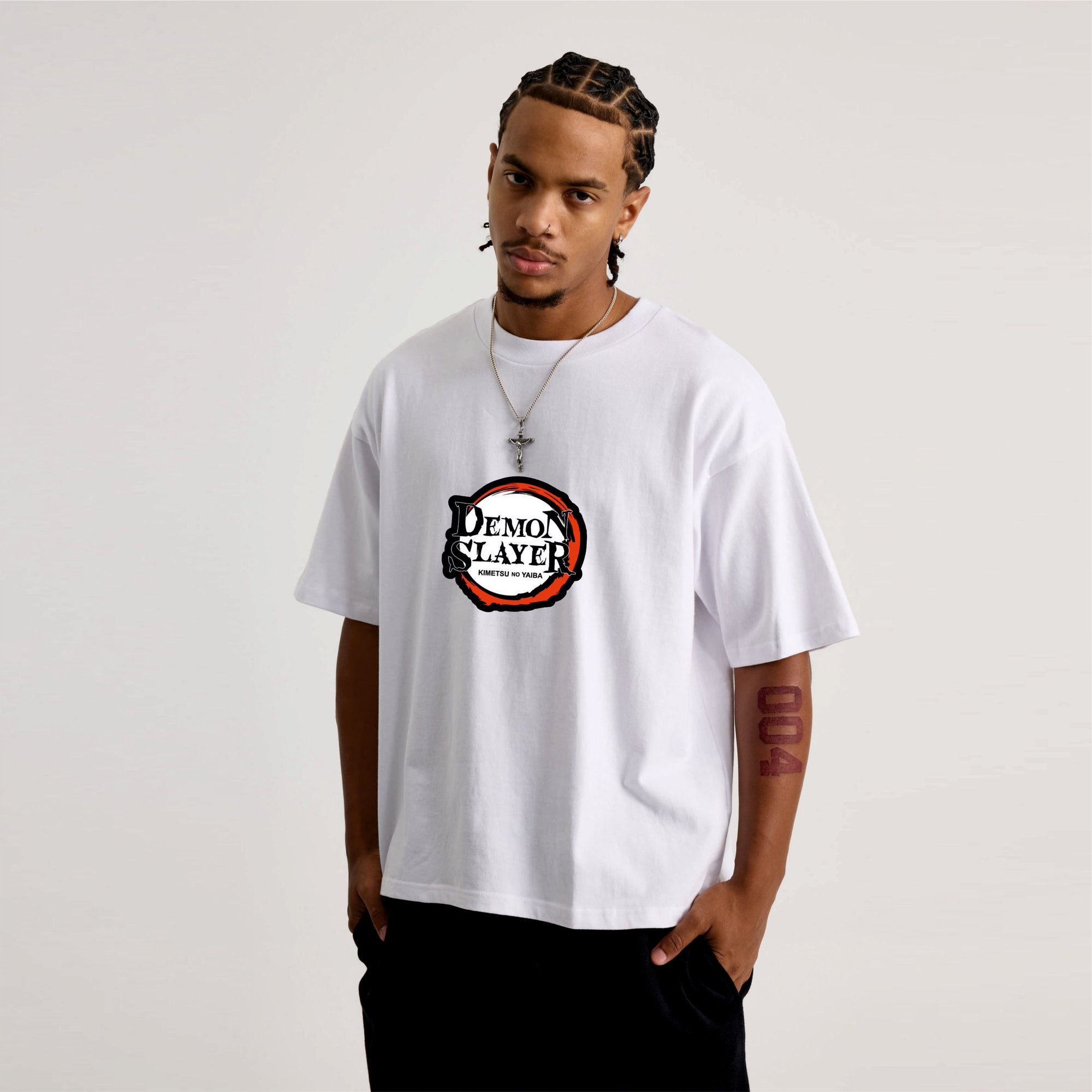 Person wearing a white t-shirt with a 'Demon Slayer' logo.