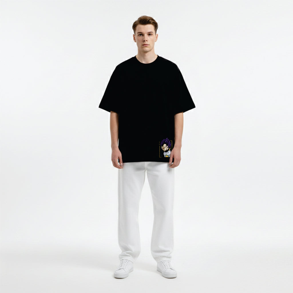 Person wearing a black oversized t-shirt and white pants on a white background