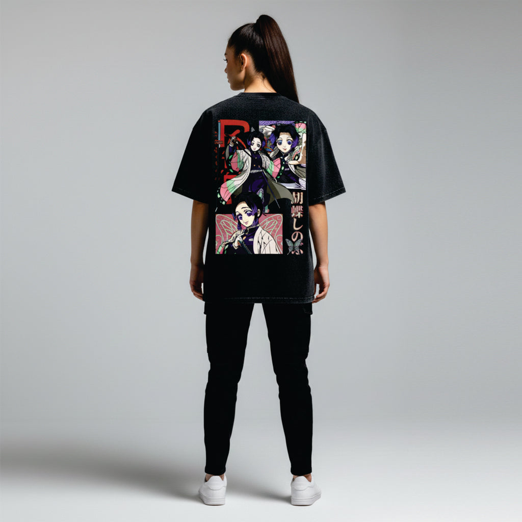 Person wearing a black t-shirt with colorful graphic design on the back against a light gray background