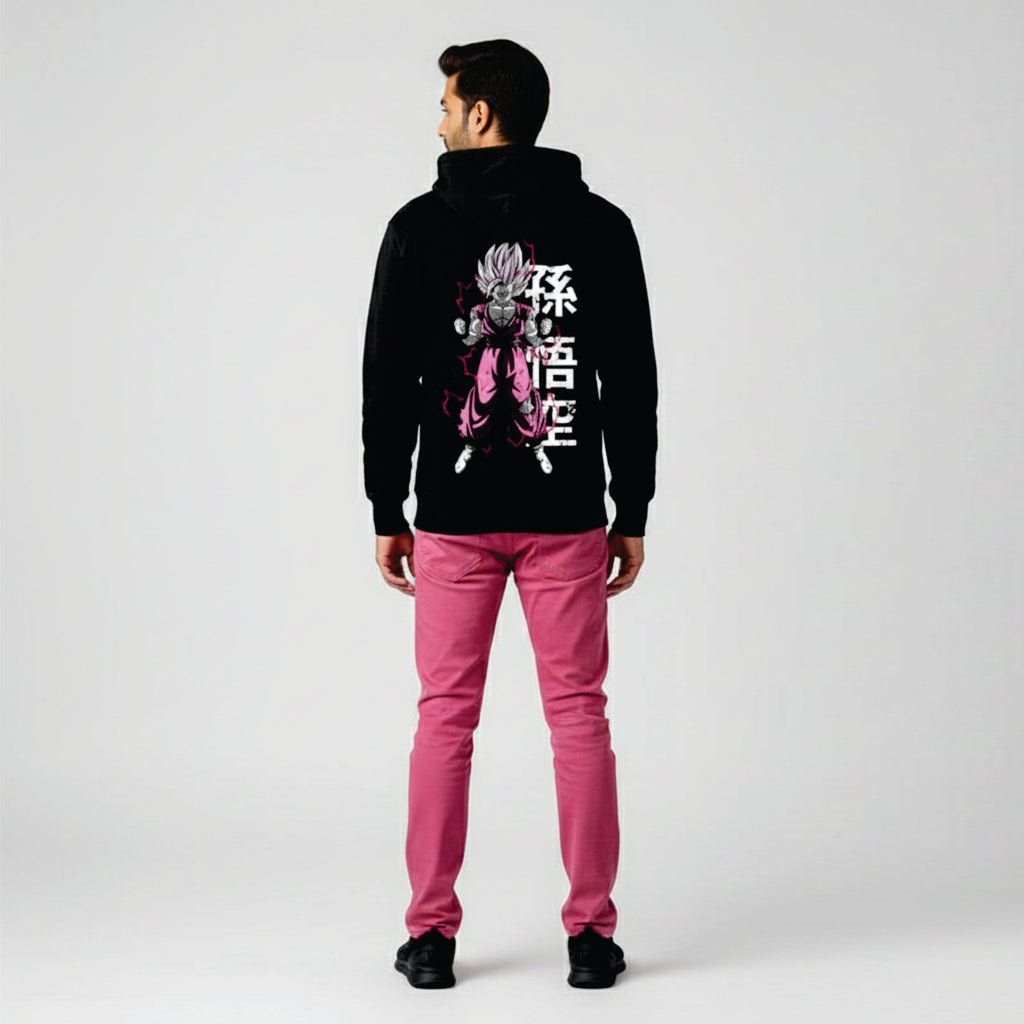 Person wearing a black hoodie with a graphic design and pink pants on a white background