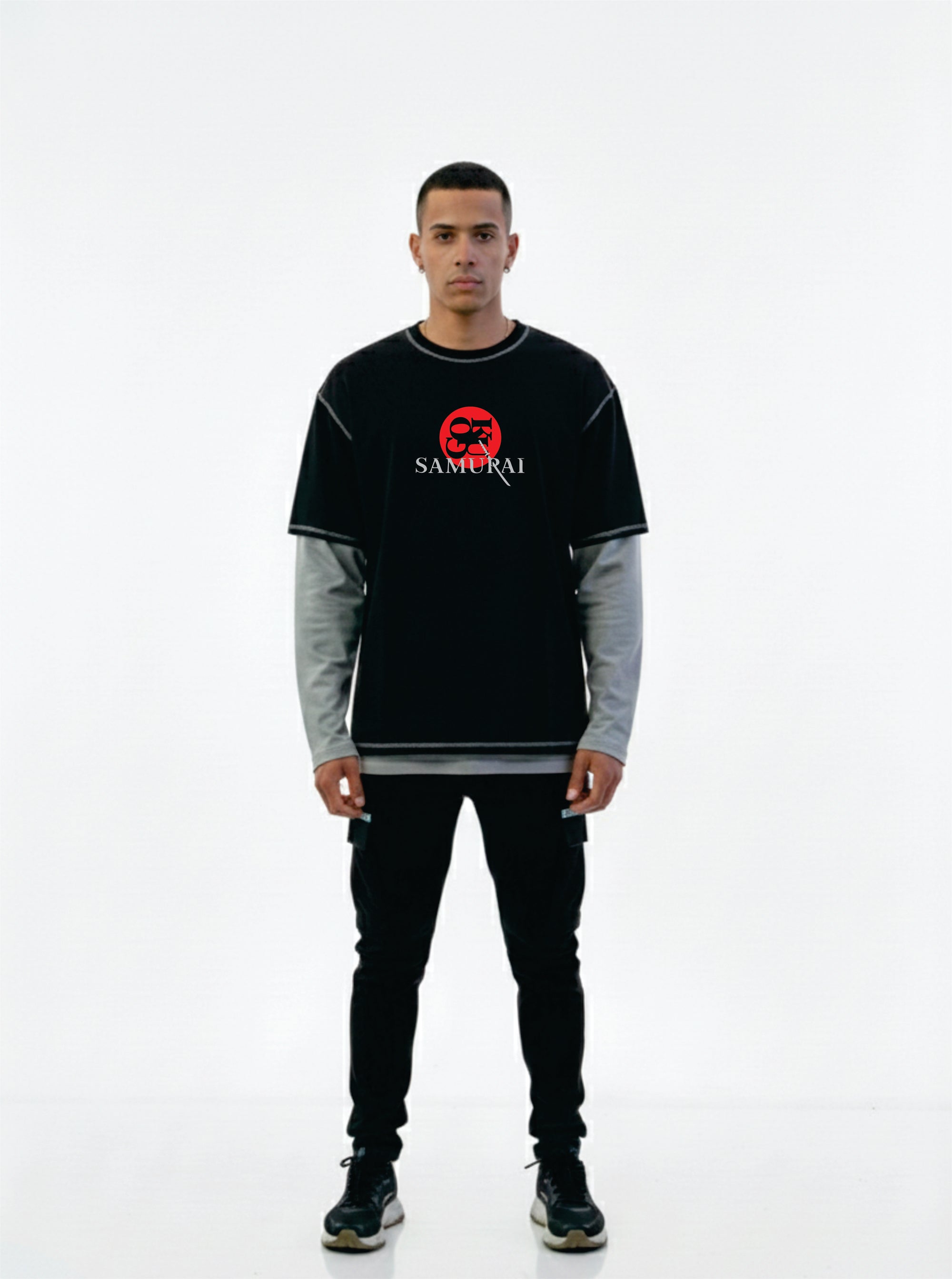 Person wearing a black and gray long-sleeve shirt with a red logo on a white background