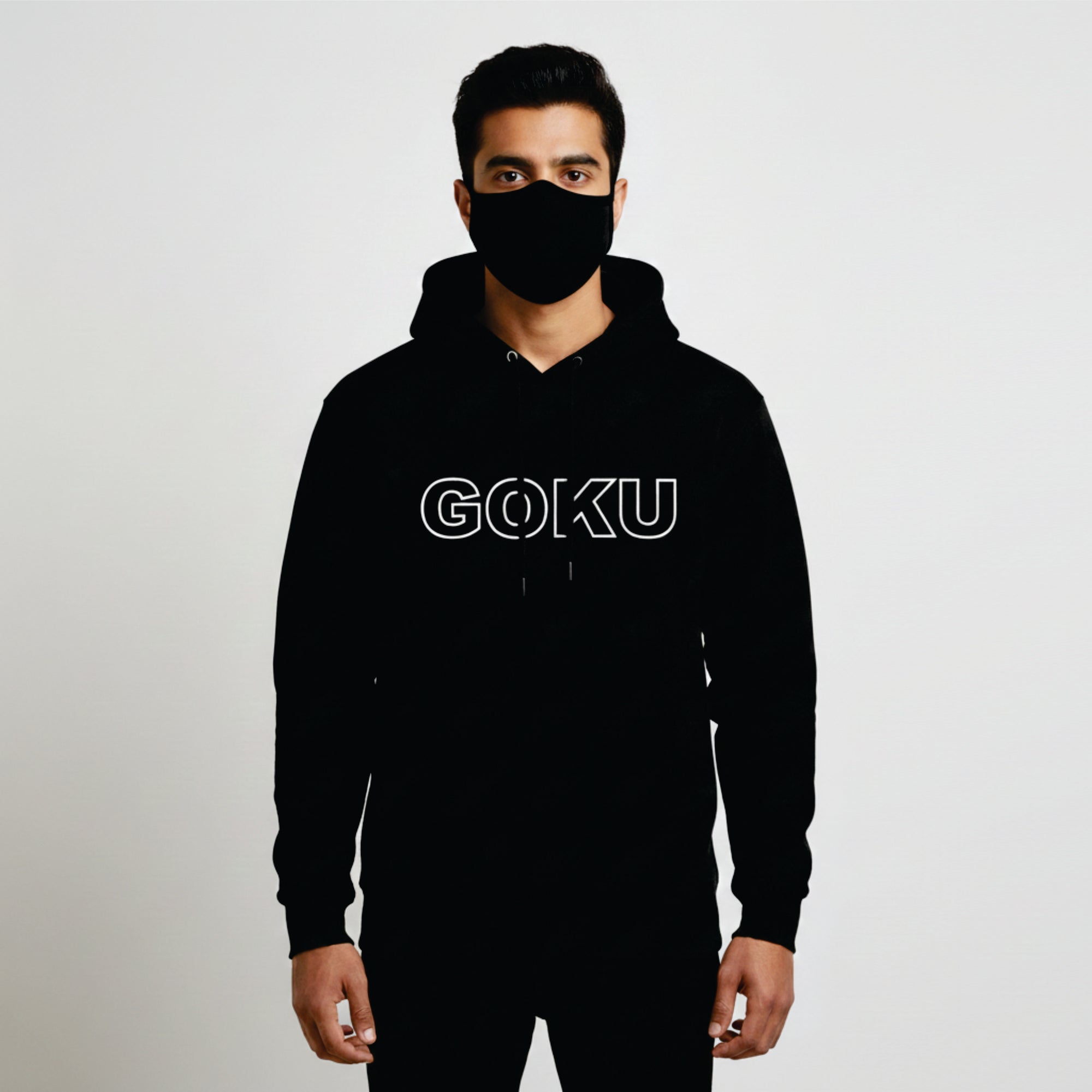 Person wearing a black hoodie with 'GOKU' text and a matching face mask on a light gray background
