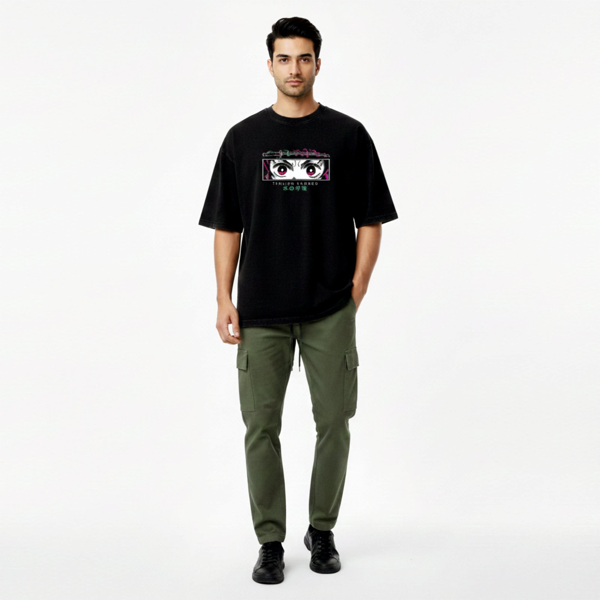 Man wearing a black t-shirt with graphic design and green pants on a white background