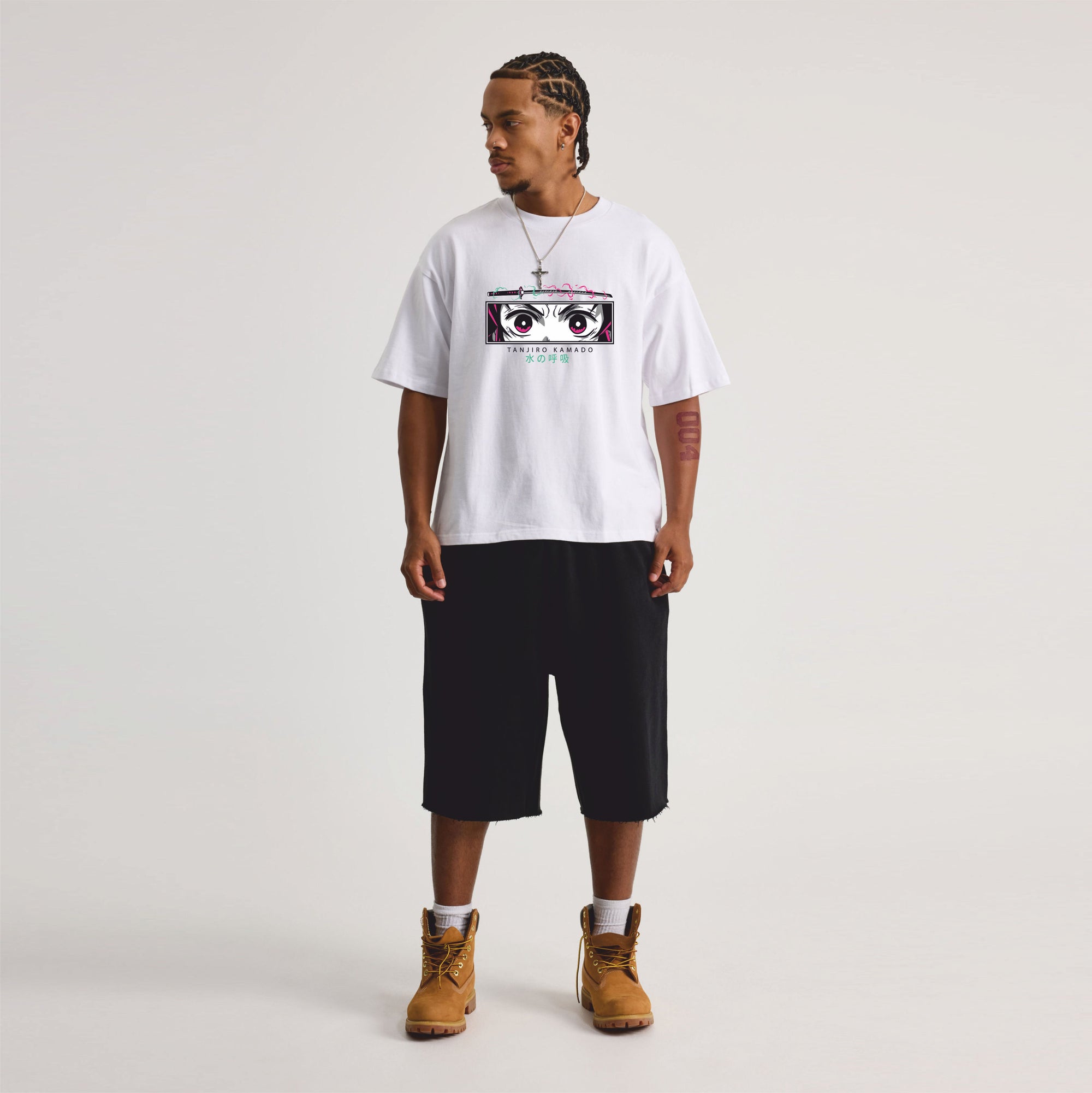 Person wearing a white t-shirt with graphic design and black shorts on a light gray background
