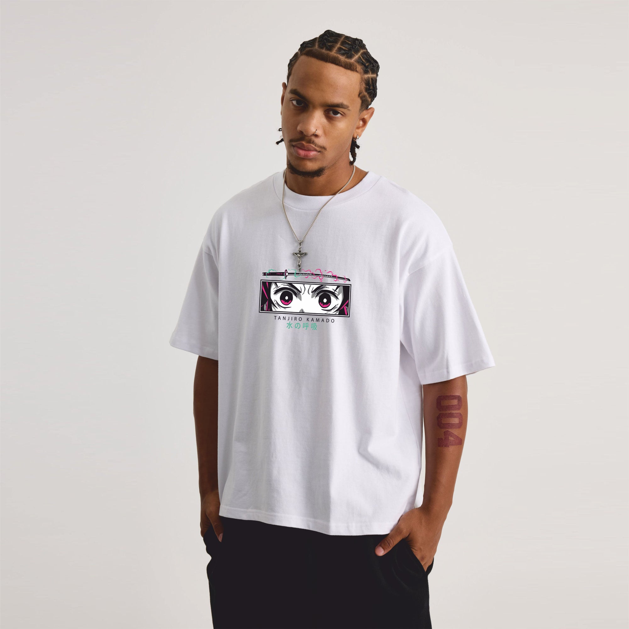 Person wearing a white t-shirt with a graphic design on a plain background
