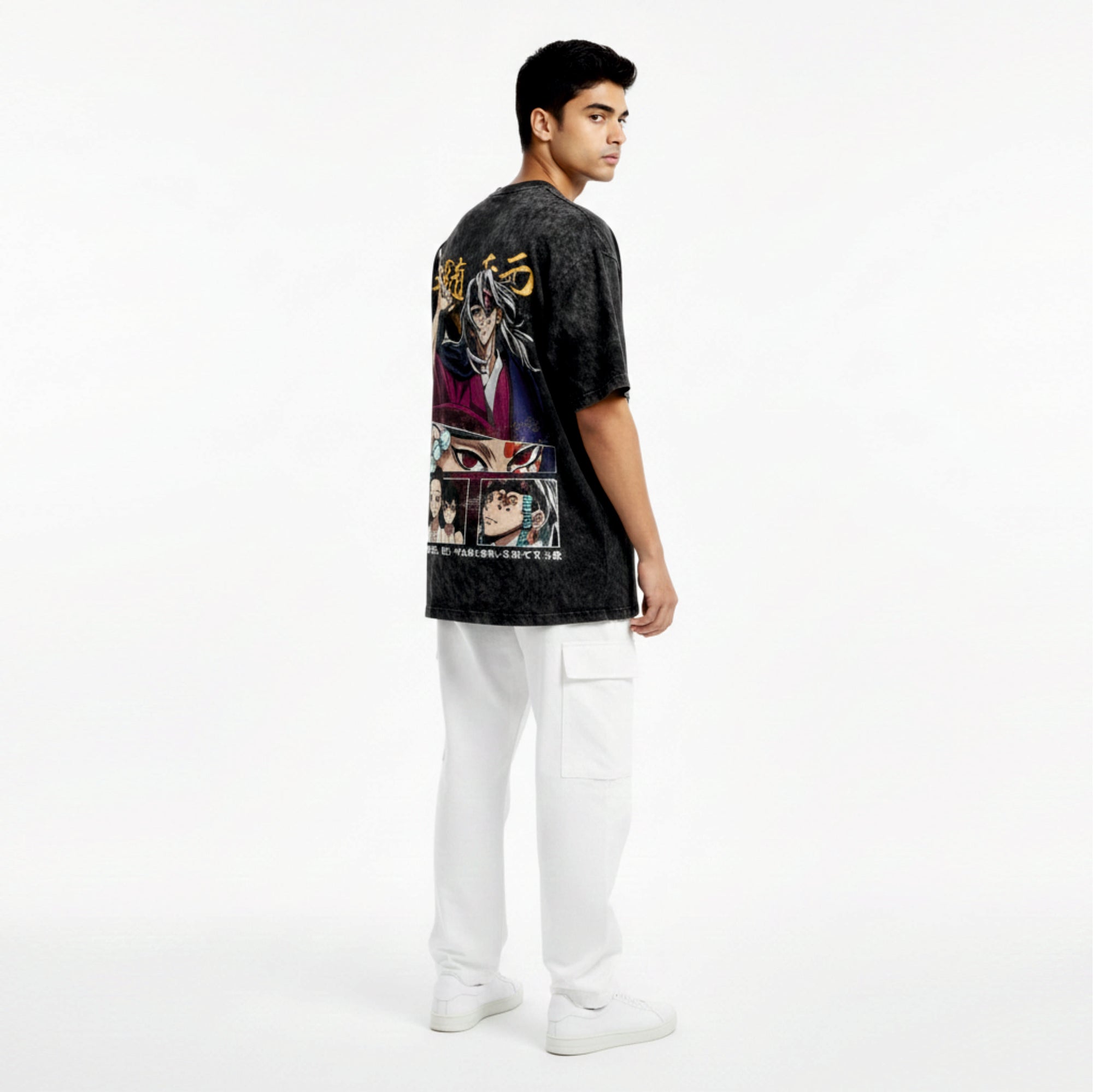 Person wearing a black t-shirt with graphic designs on a white background