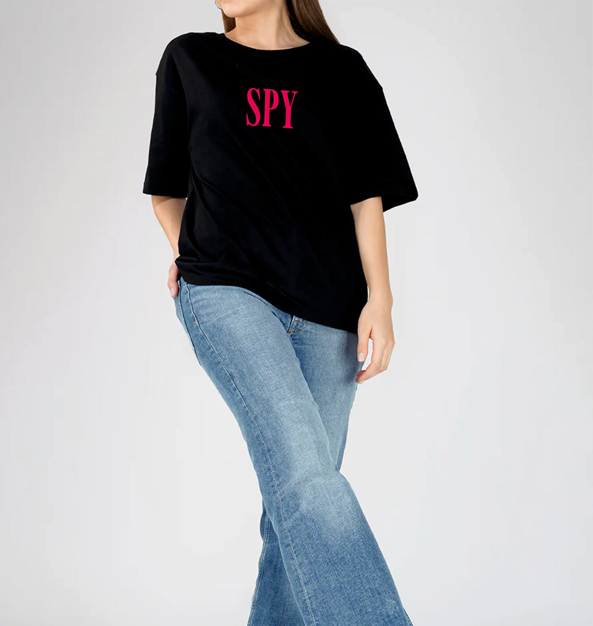 Person wearing a black t-shirt with 'SPY' in pink