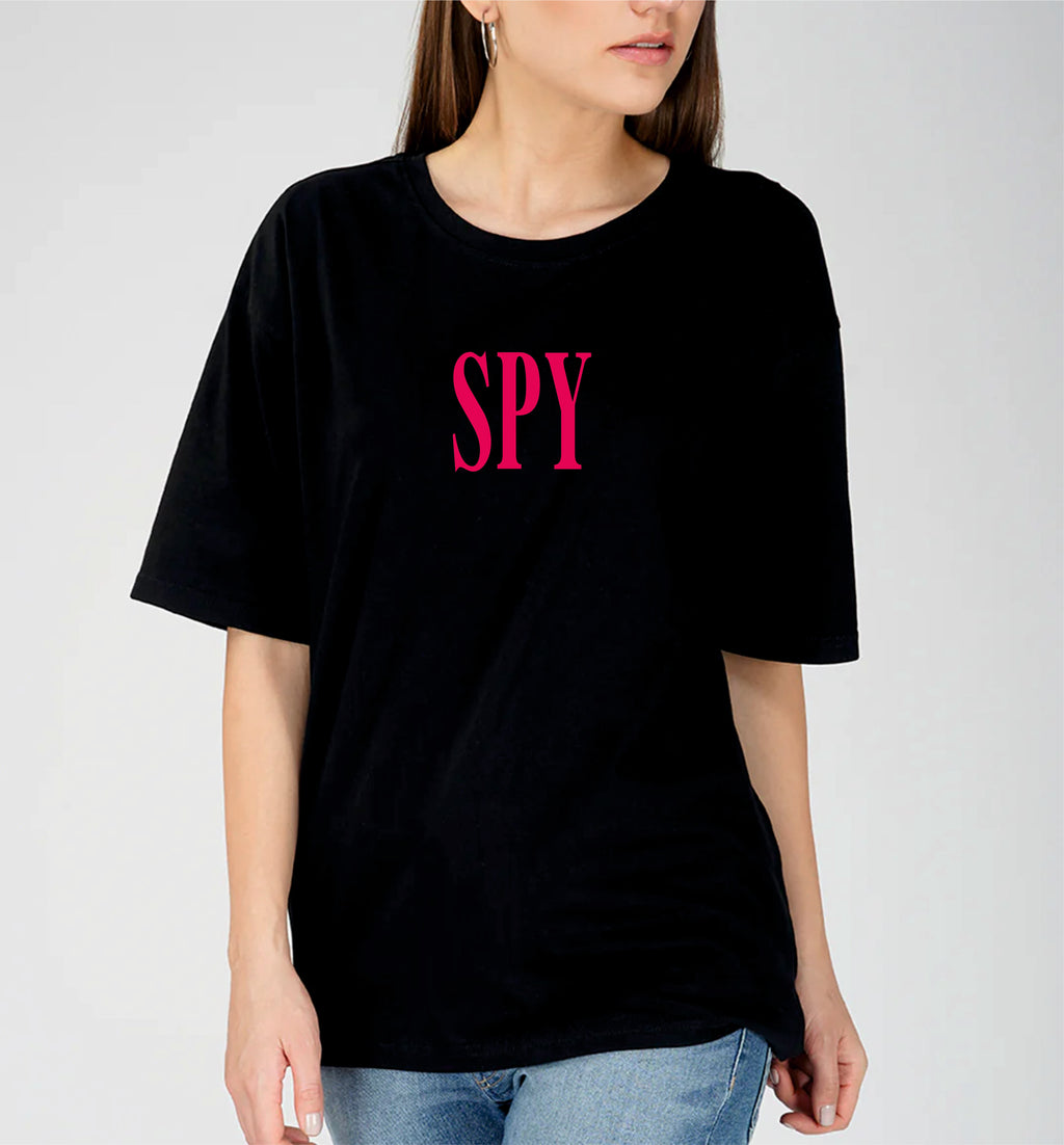 Person wearing a black t-shirt with 'SPY' in pink letters