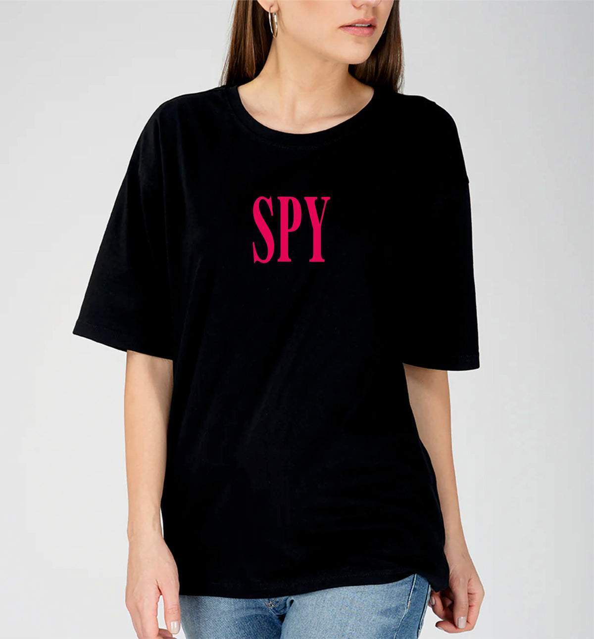 Person wearing a black t-shirt with 'SPY' in pink letters