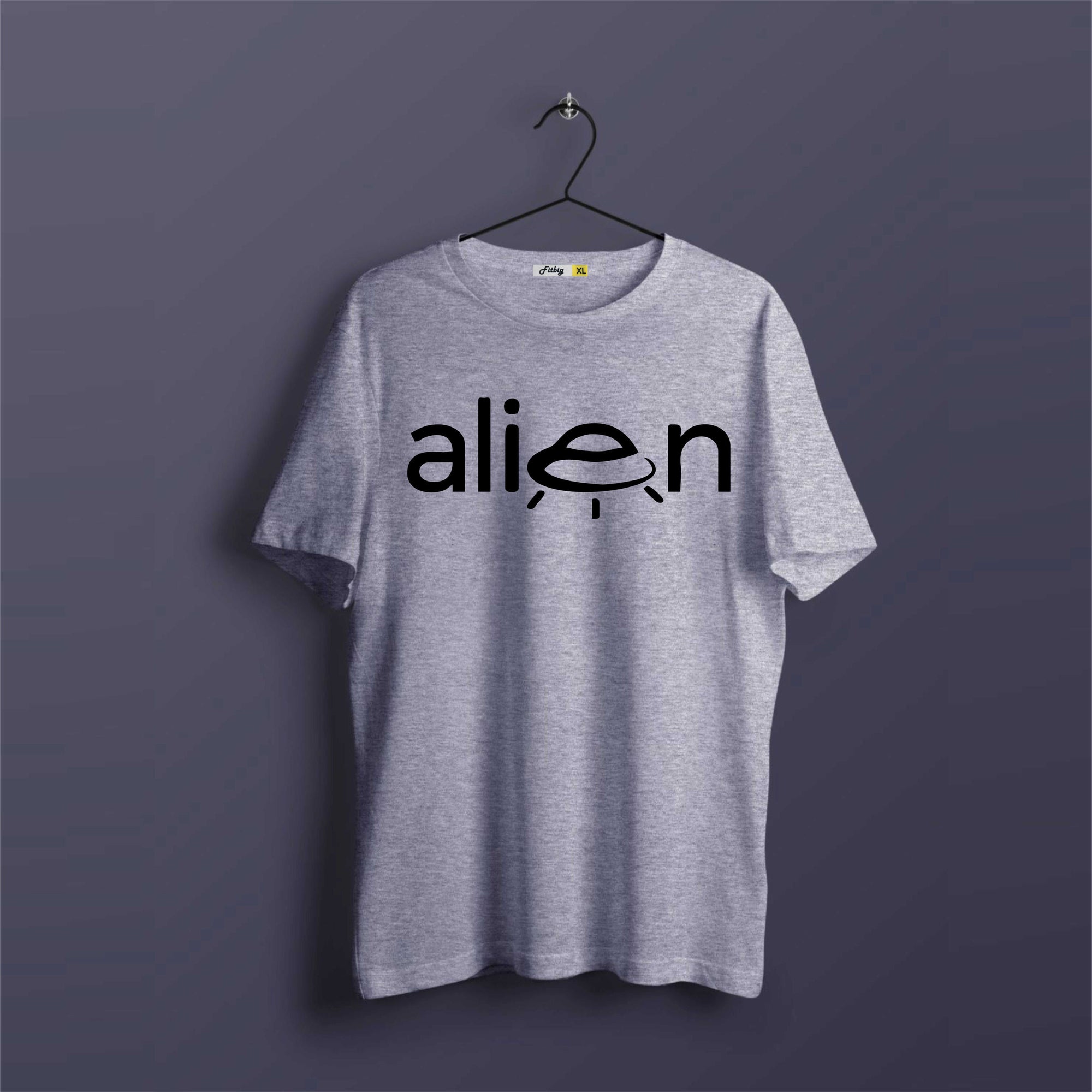 Gray t-shirt with 'alien' graphic on a hanger against a dark background