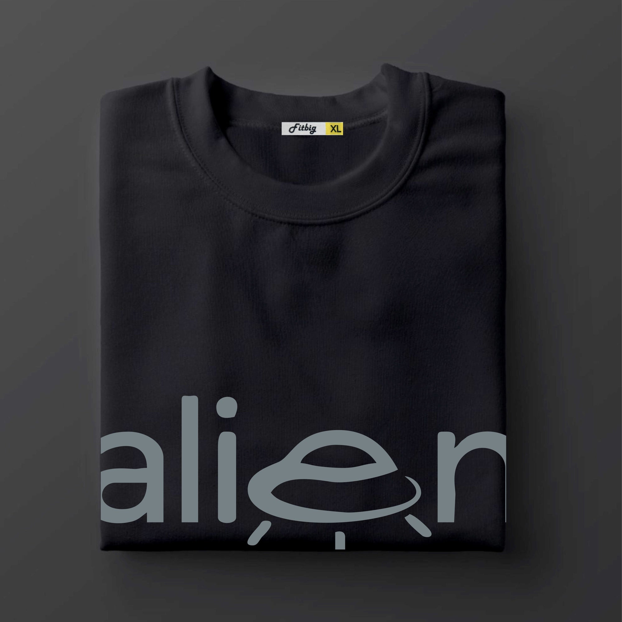 Black t shirt with 'alien' design on a dark background