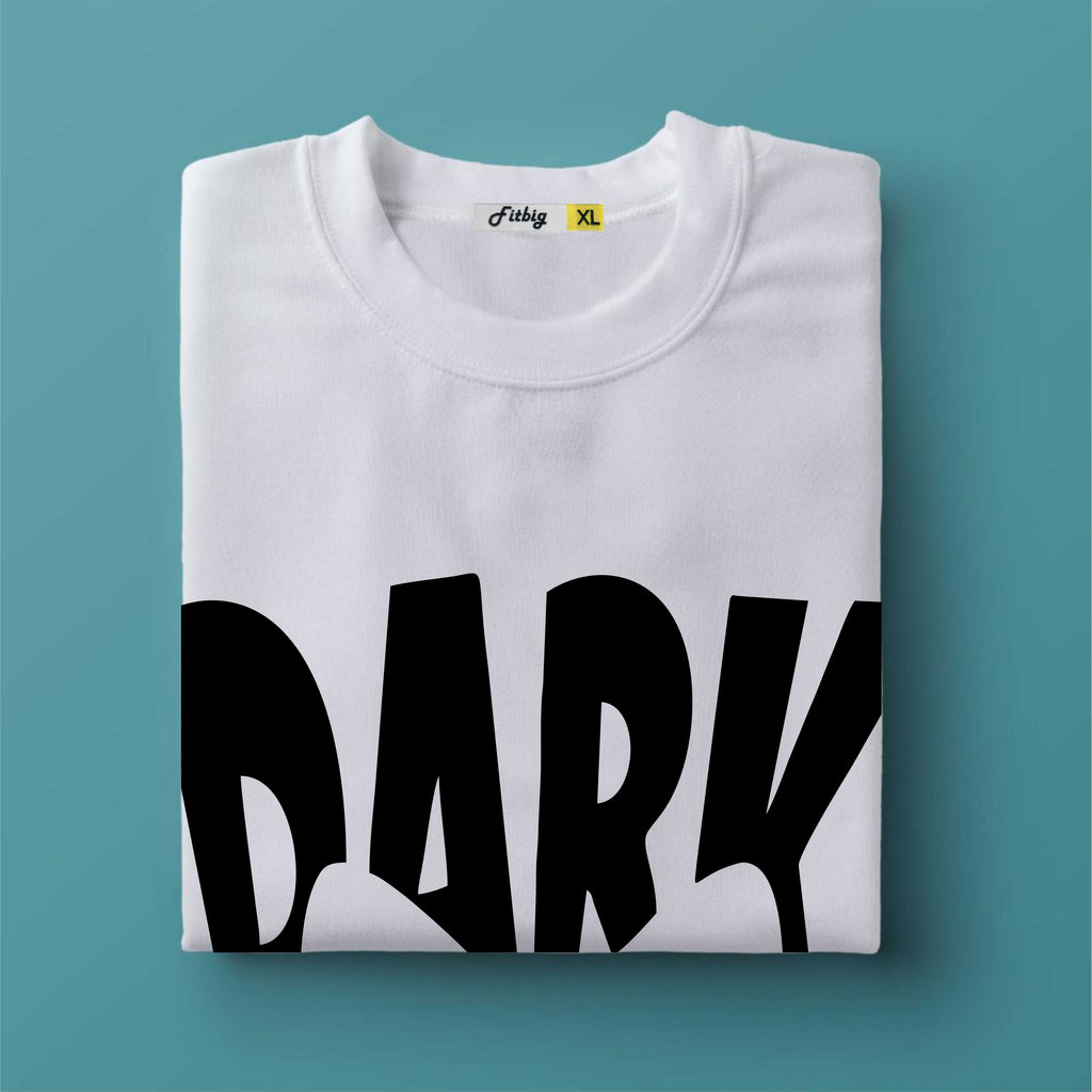 Folded white t-shirt with 'DARK' printed in black on a teal background